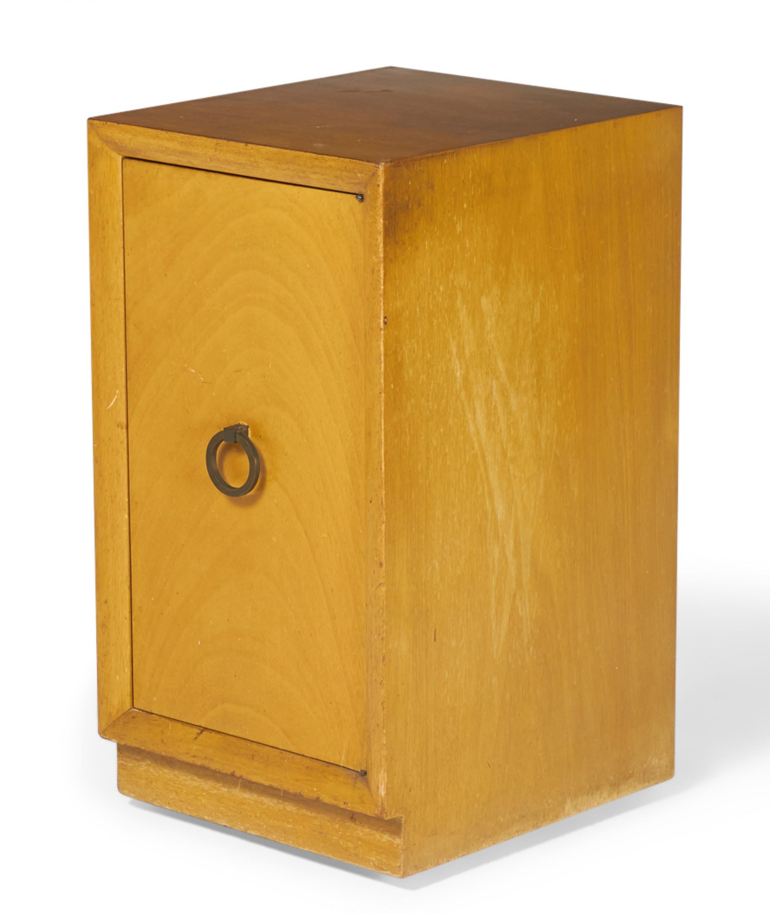 Pair of American mid-century blond maple nightstands / tall cabinets with a single compartment concealed by a hinged door with a brass ring door pull. (WIDDICOMB MODERN)(PRICED AS PAIR)(Similar cabinet: DUF0149A)
 