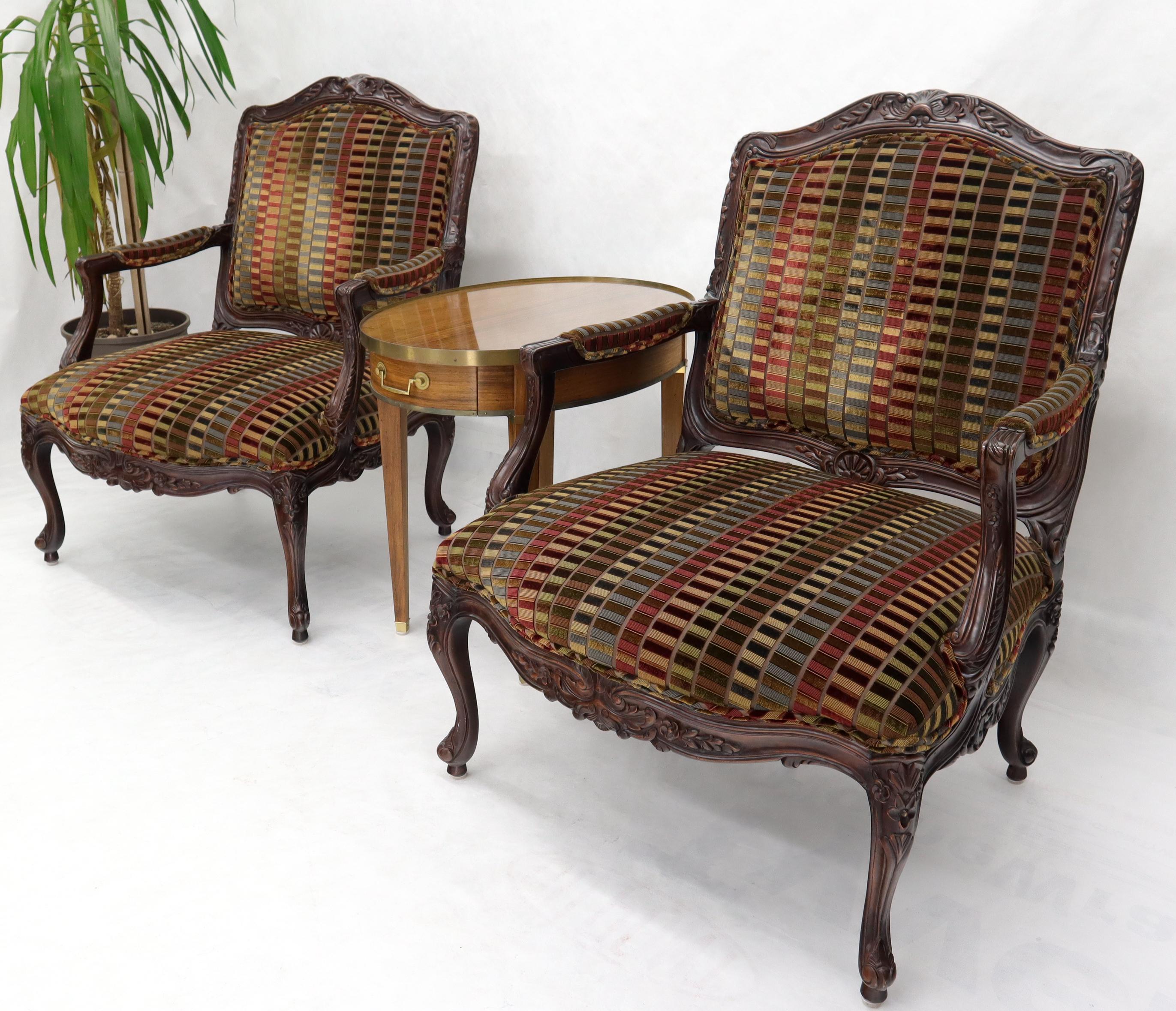 Pair of carved patterned multi-color velvet like upholstery lounge armchairs extra wide seats.