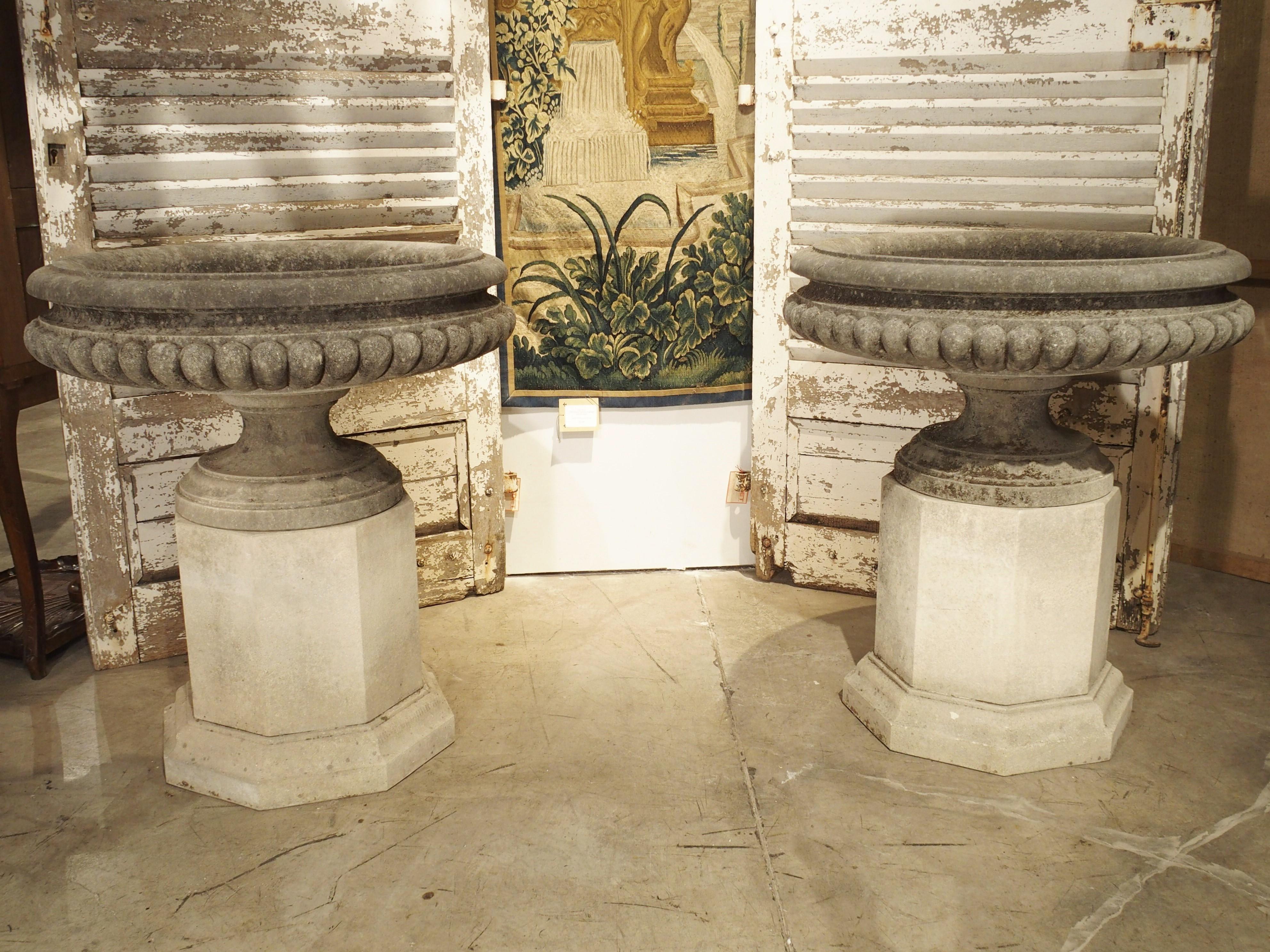 Pair of Wide Lobed Stone Urns on Octagonal Plinths 13