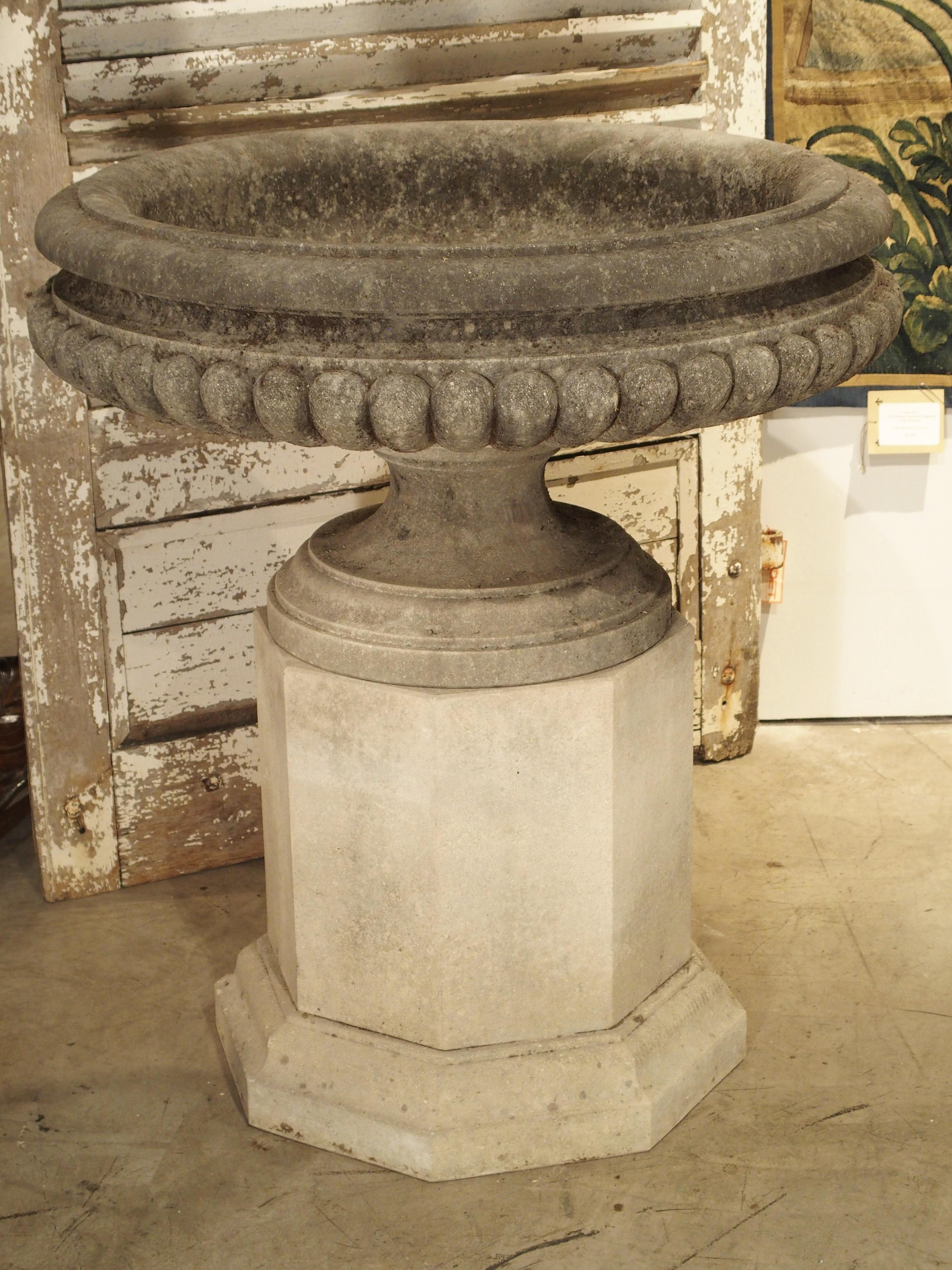 Hand-Carved Pair of Wide Lobed Stone Urns on Octagonal Plinths
