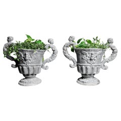 Pair of William and Mary pattern Lead urns.