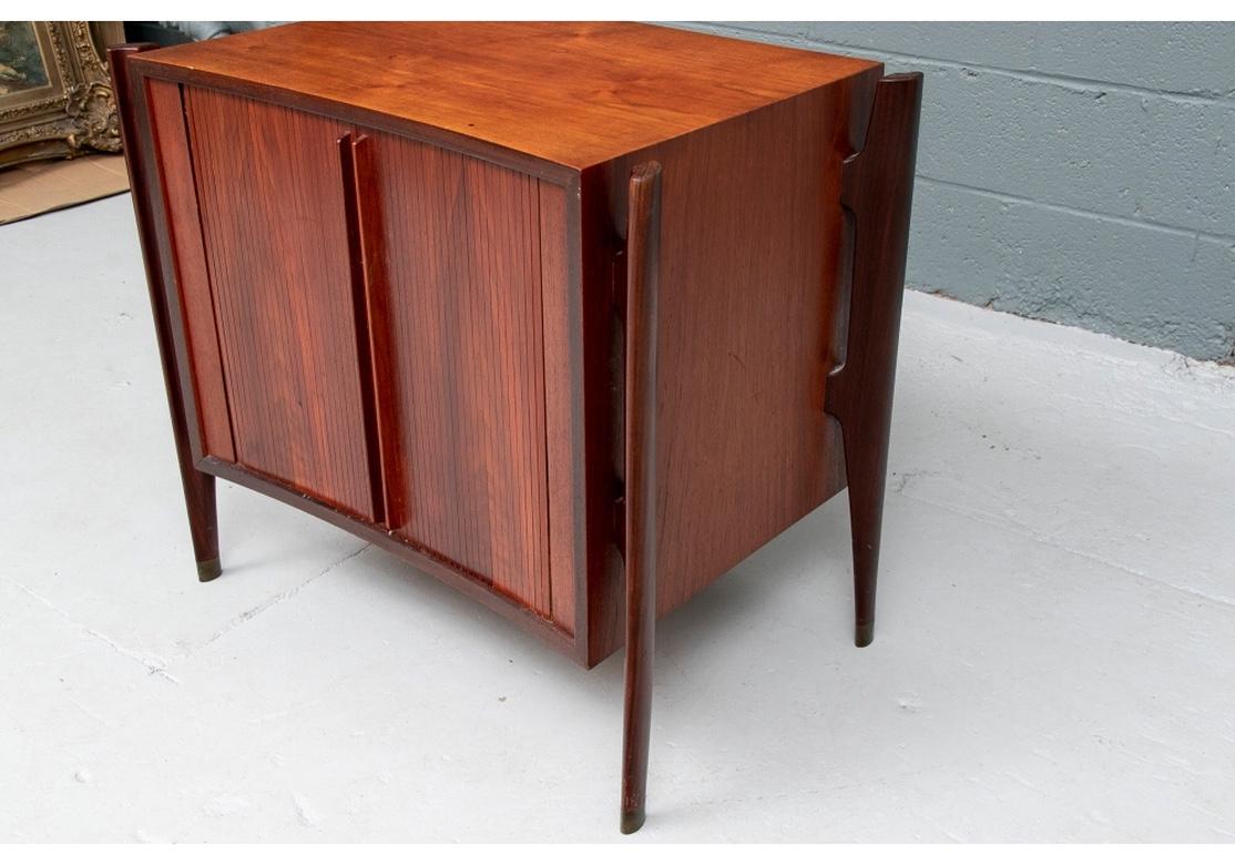 A rare pair of Scandinavian Modern William Hinn design Exoskeleton Nightstands with Tambour Doors. The stands with separately made shaped tapering supports on the front and back corners. With twin tambour doors opening to a single shelf. 
Measures:
