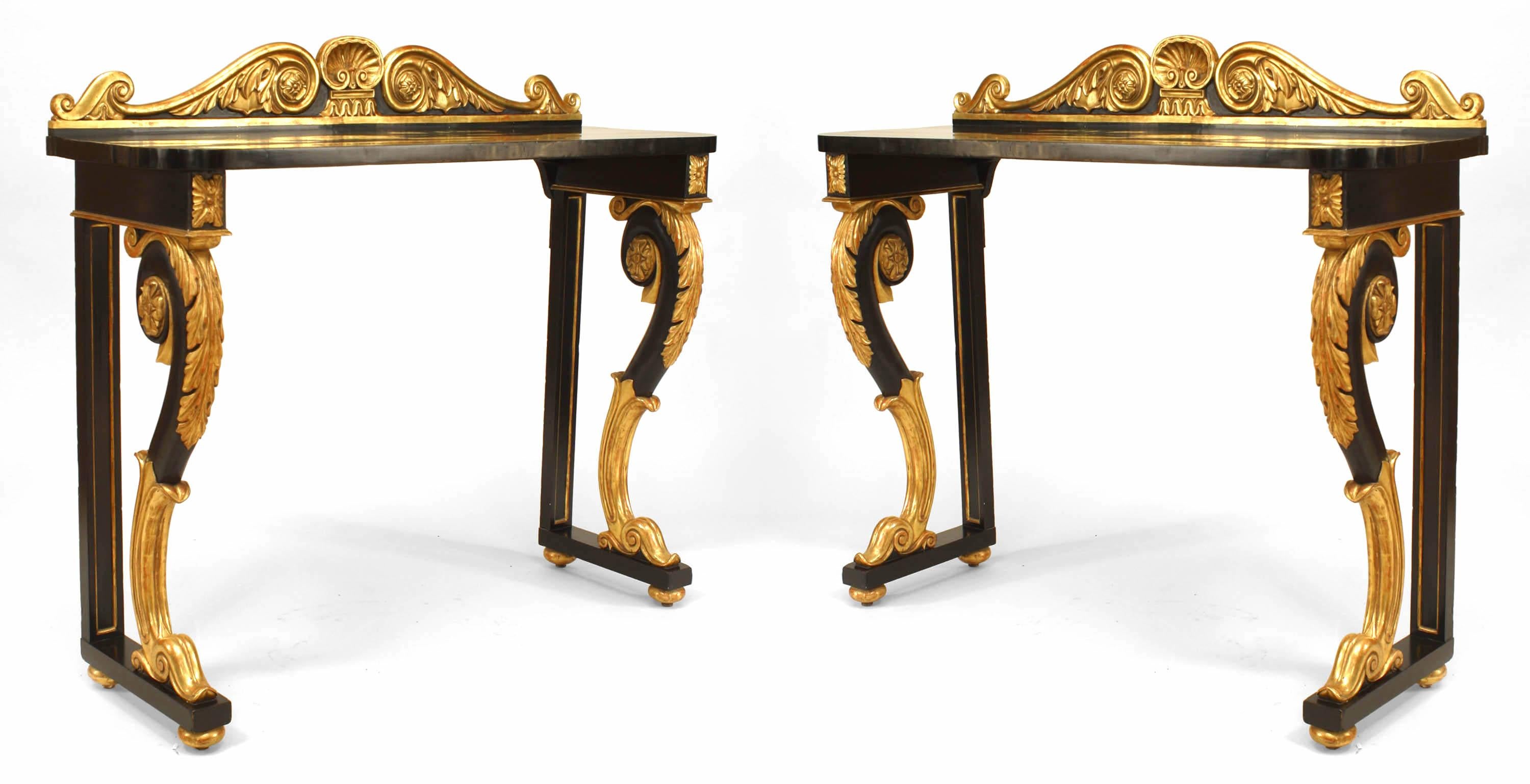 Pair of English Regency-style (19th Century) ebonized and gilt trimmed scroll leg console tables with carved back rail.
