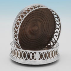 Pair of William IV period sterling silver wine coasters made by Barnards in 1830