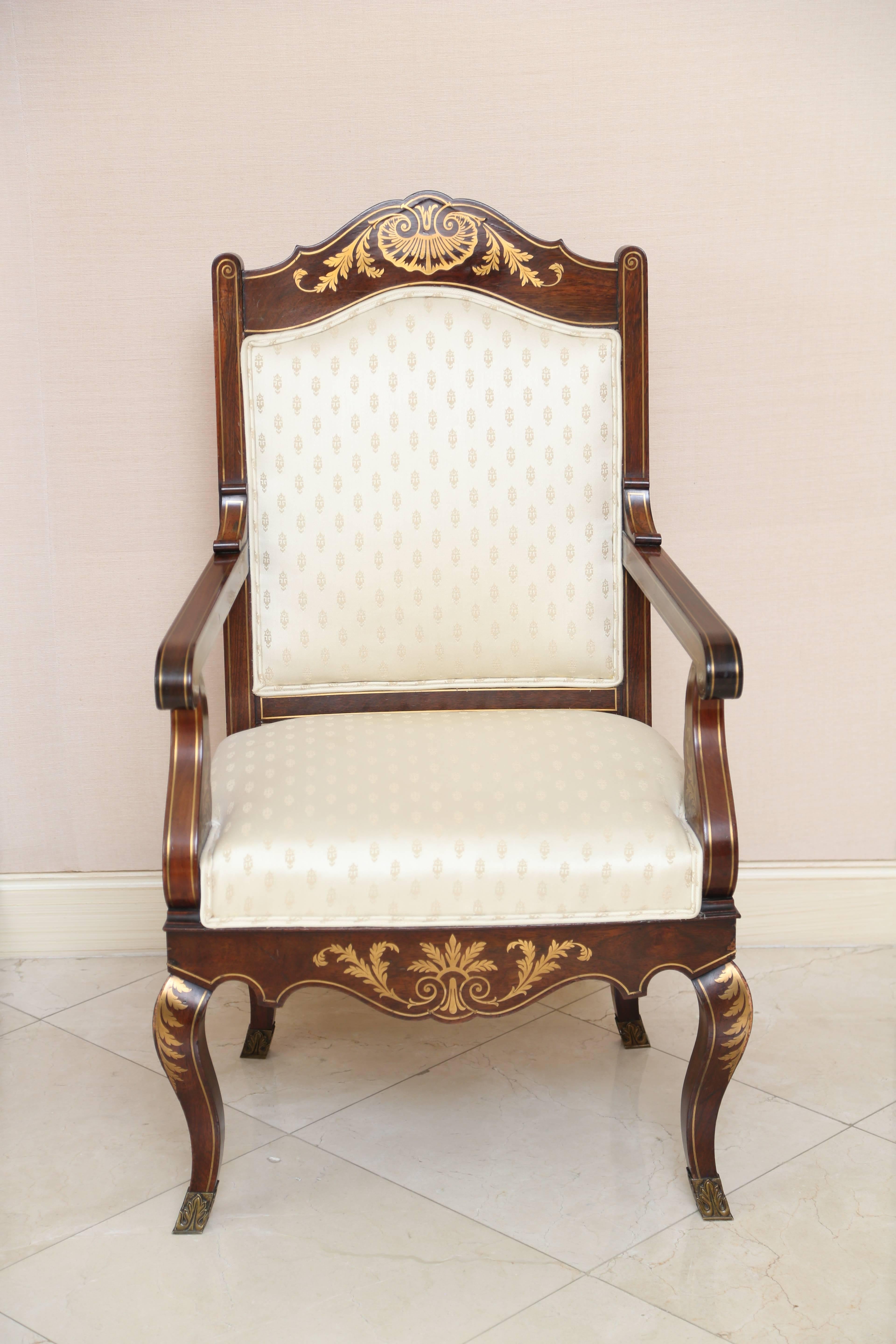 Each upholstered back with arched crest rail centered by a brass-inlaid shell issuing foliate sprays; the over-upholstered seat with shaped sear rail centered by a sheet sheath; raised ob cabriole legs terminating in sabot; with brass line inlay