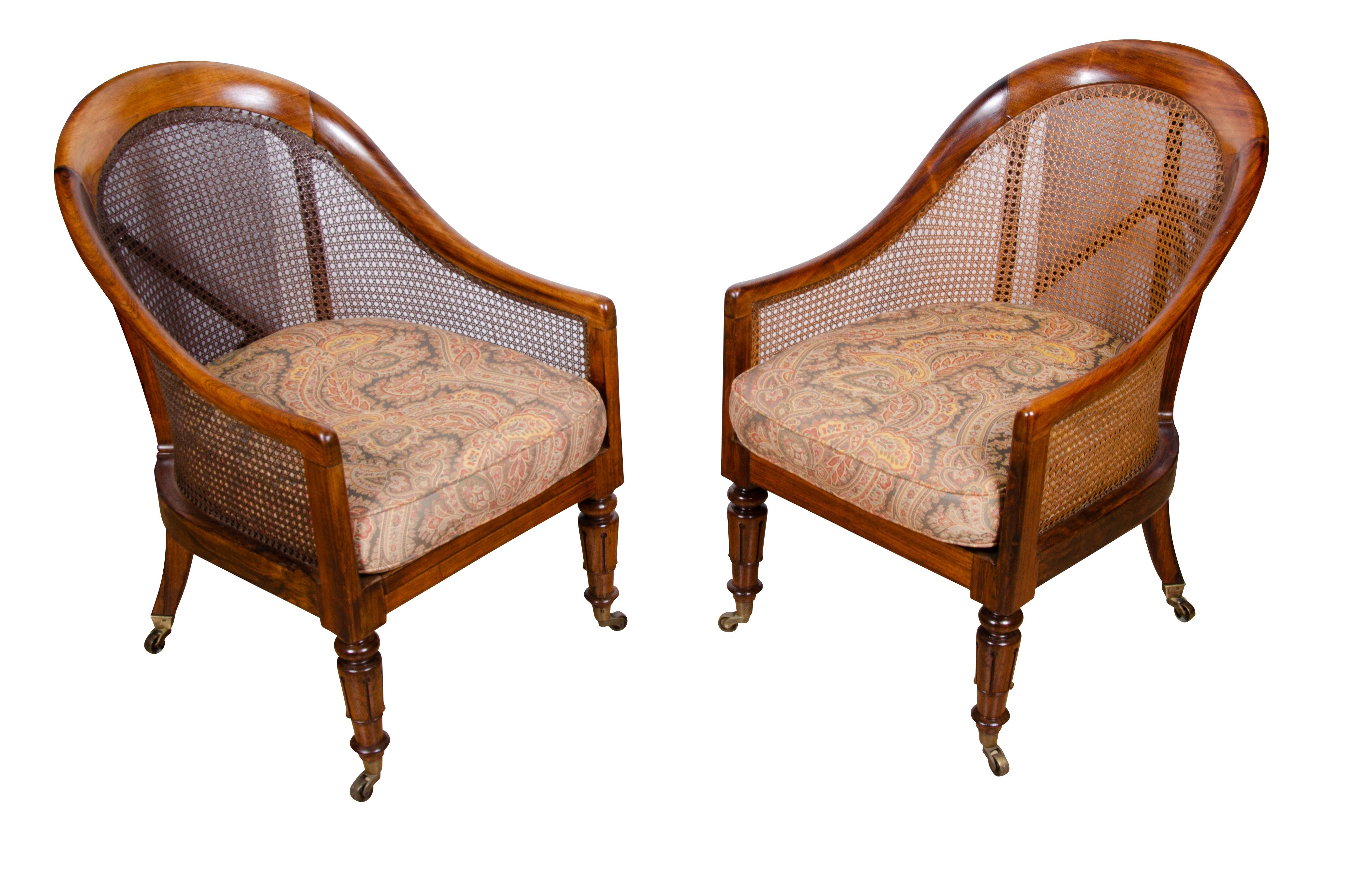 Nice pair of solid rosewood chair with caning in good condition. Wood seats. Raised on circular tapered legs with casters.