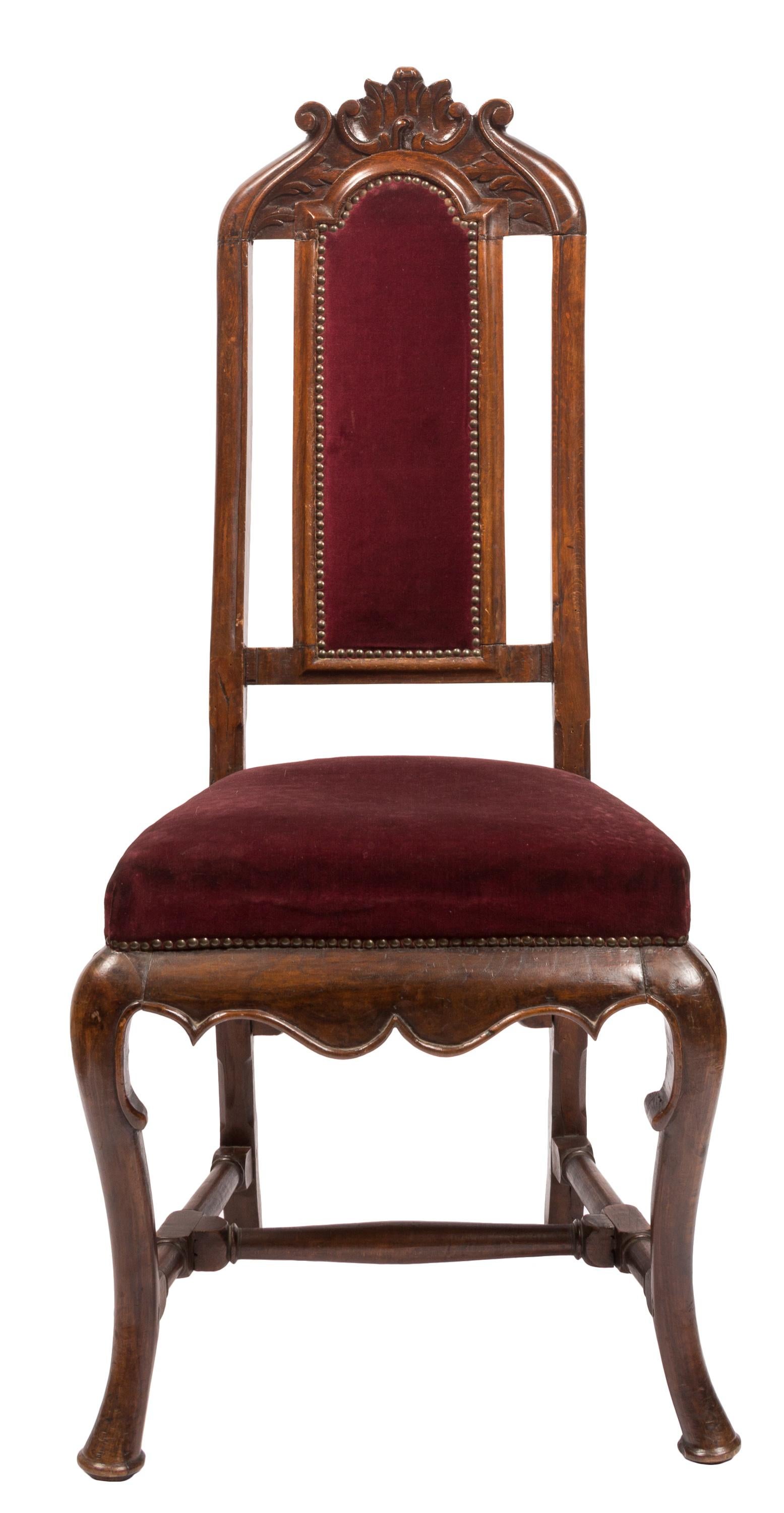 Matched pair of 18th century William & Mary transition to Queen Anne style side chairs with hand carved details. Upholstered with burgundy red velvet fabric featuring brass tacked edges. Crafted in Spain of native walnut, the chairs show the strong