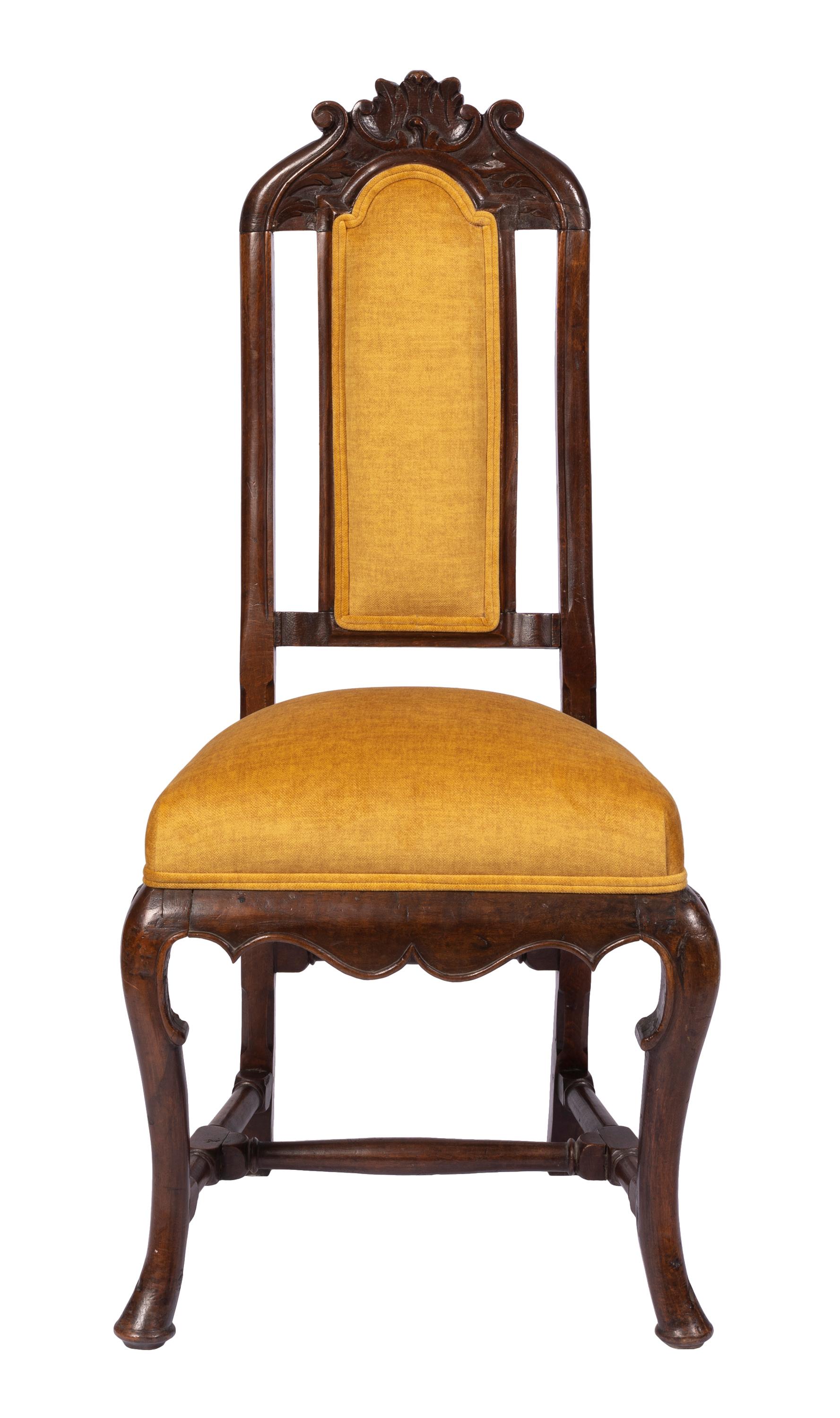 Matched pair of 18th century William & Mary transition to Queen Anne style side chairs with hand carved details. Hand-crafted in Spain from native walnut, the chairs show the strong influence of English furniture styles that had arrived in the