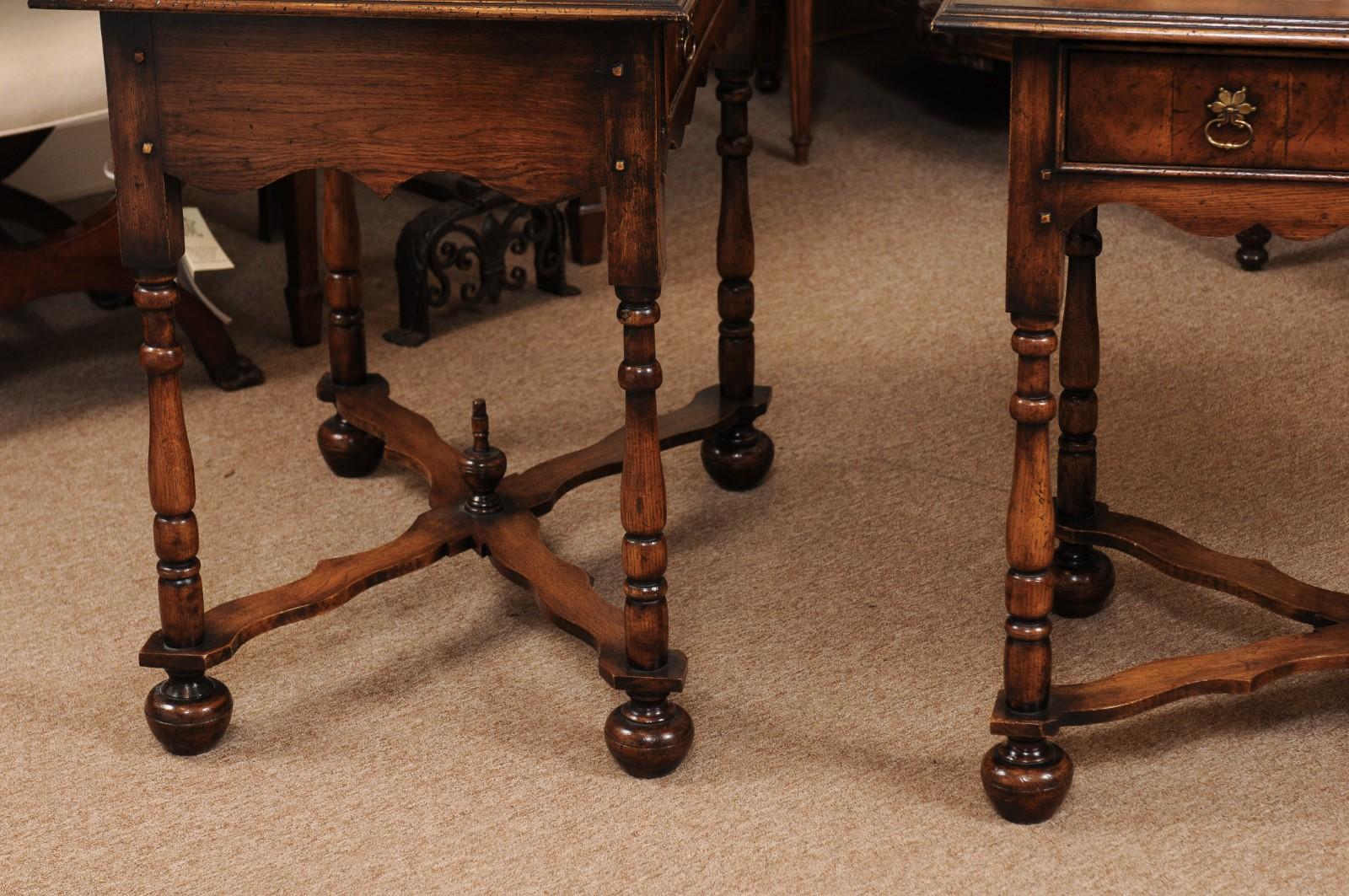 The pair of William & Mary style oyster veneer walnut side tables with drawer, shaped apron, turned legs, X-stretcher terminating in rounded feet.
   