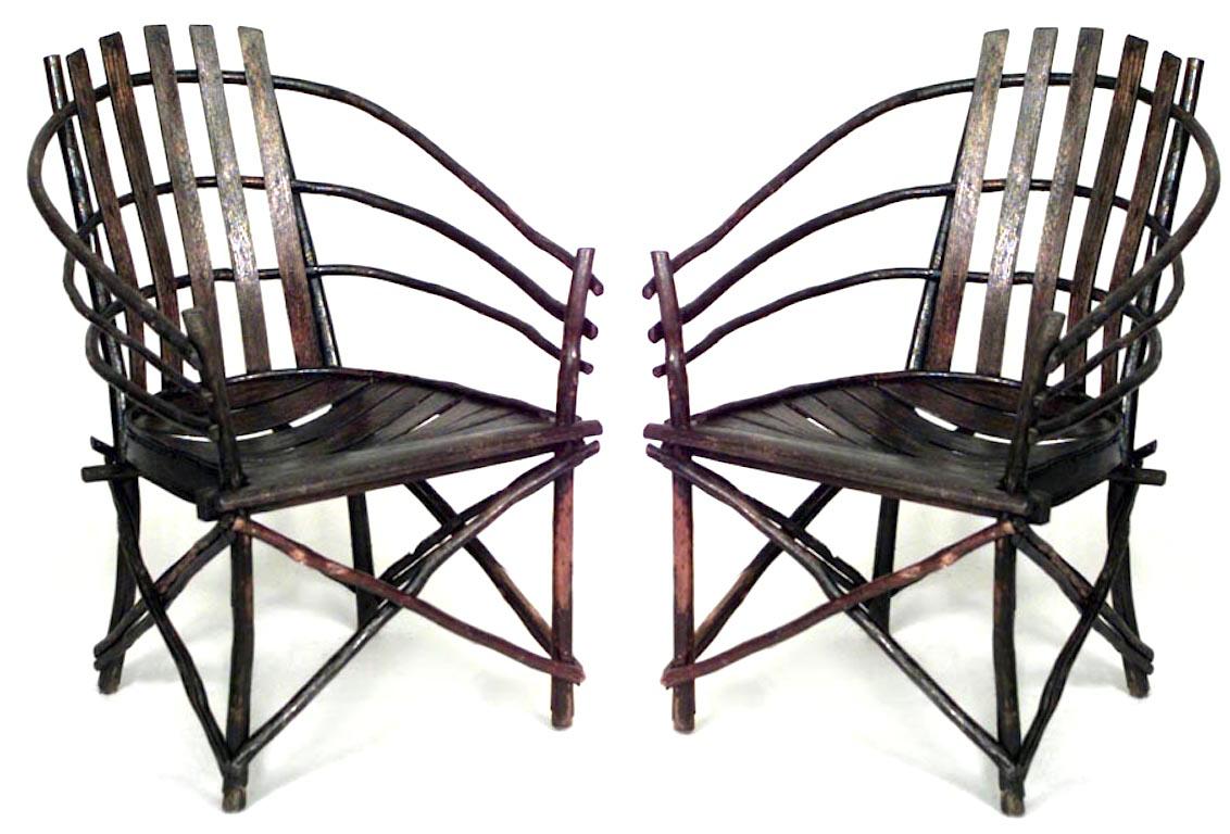 Pair of willow Adirondack armchairs featuring a barrel-back design and slat seats.