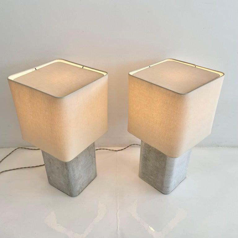 Stunning concrete Willy Guhl lamps by Eternit with teak top cover. Concrete cubes made in Switzerland. Newly fitted as a lamp, re-wired with a new custom linen shade and light diffusor on top. Stunning simplicity and beautiful texture make these