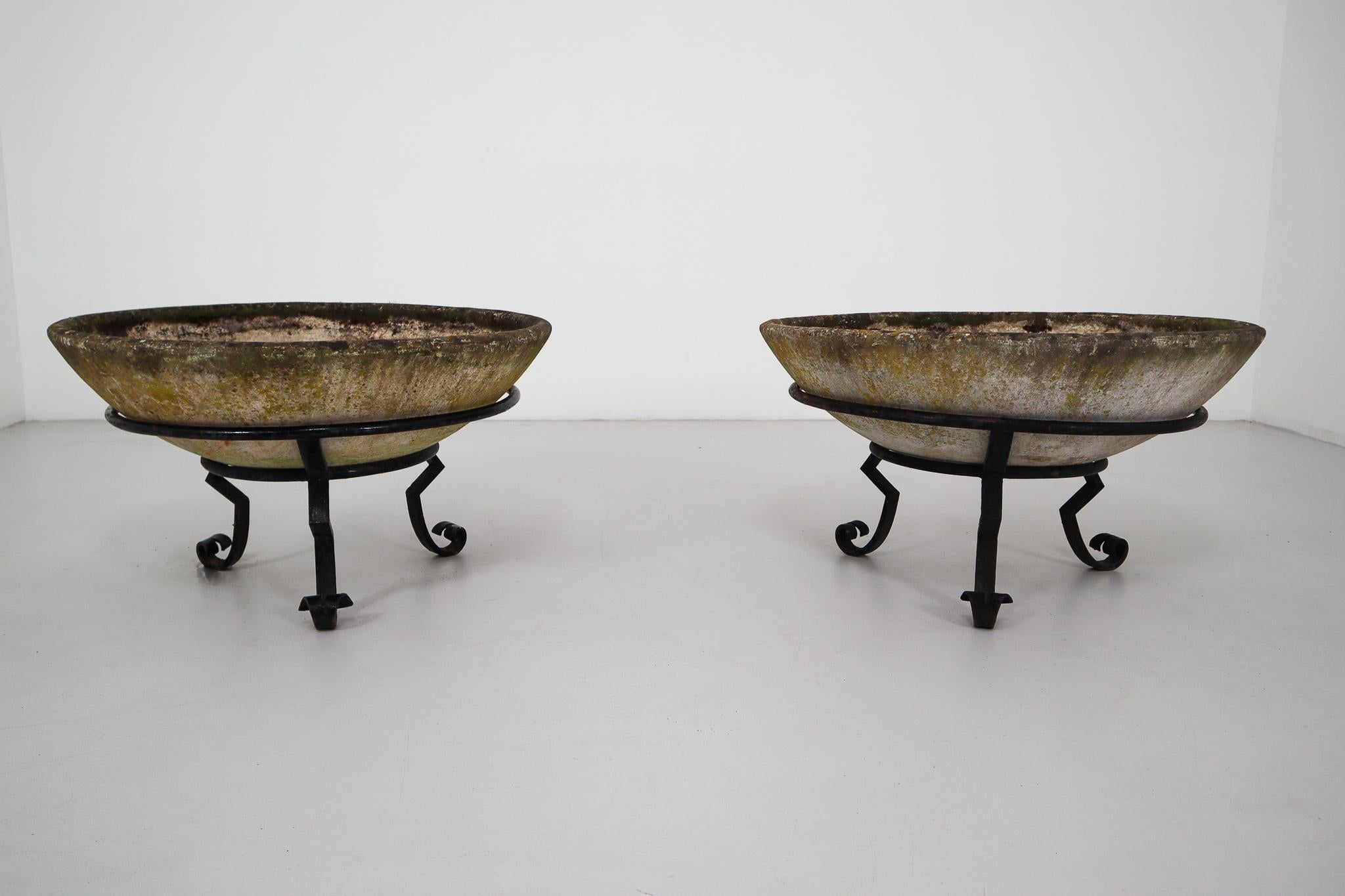 A fine pair of Mid-Century Modern large saucer planters of composition stone for an indoor or outdoor garden, garden room, or terrace, designed by the iconic Willy Guhl in the early 1960s. They have a lovely naturally-weathered surface.