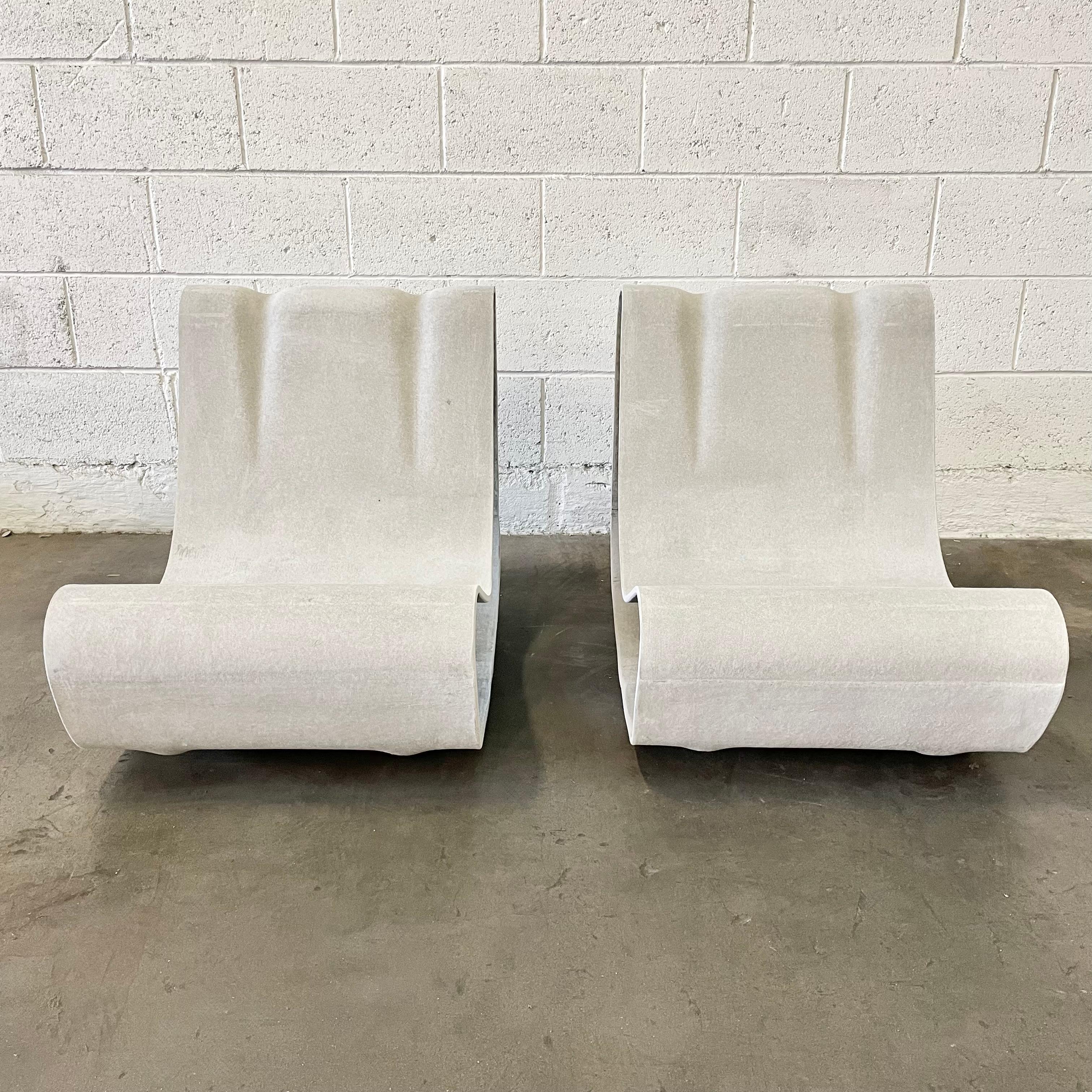 Meet the chairs that bend, but never break the rules of design. Willy Guhl’s iconic Loop Chairs, offered here as a striking pair, are formed from continuous ribbons of sculptural cement, each one capturing that seamless, flowing silhouette Guhl is