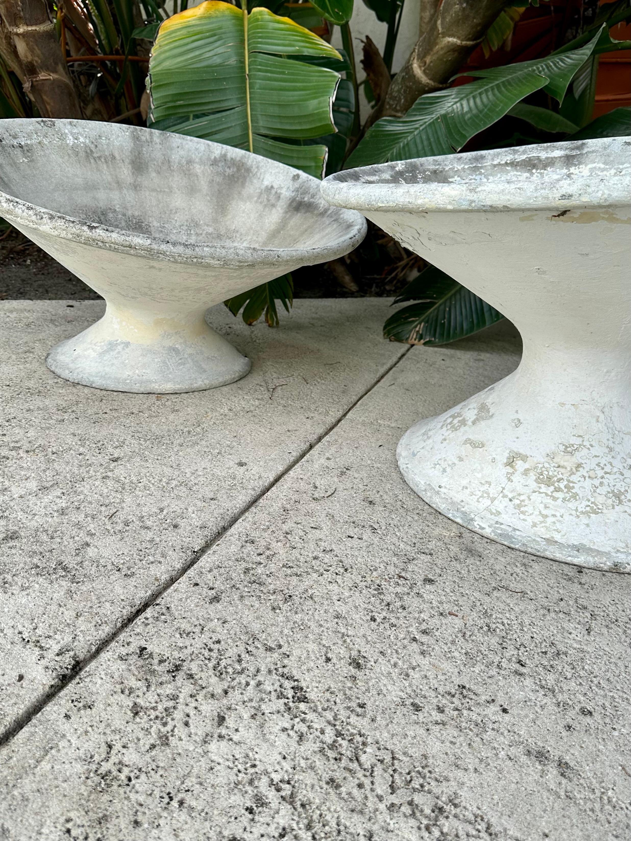 Vintage pair of a-symmetrical planters by Swiss Designer, Willy Guhl.  Good vintage condition, with some wear and chips along the bottom edges.  Marked with numbers inside.  This pair consists of 2 different sizes and are hard to find in the US. 