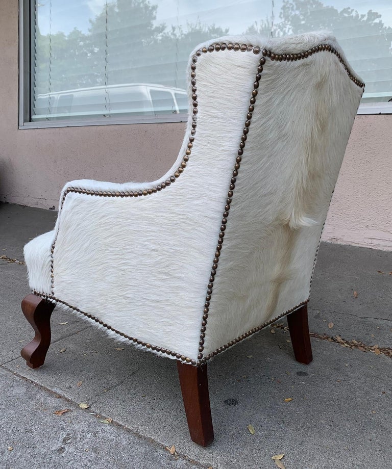 Pair of Wingback Chairs 1 in Brown Cowhide and 1 in White Cowhide