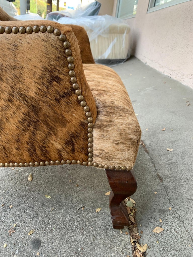 Pair of Wingback Chairs 1 in Brown Cowhide and 1 in White Cowhide