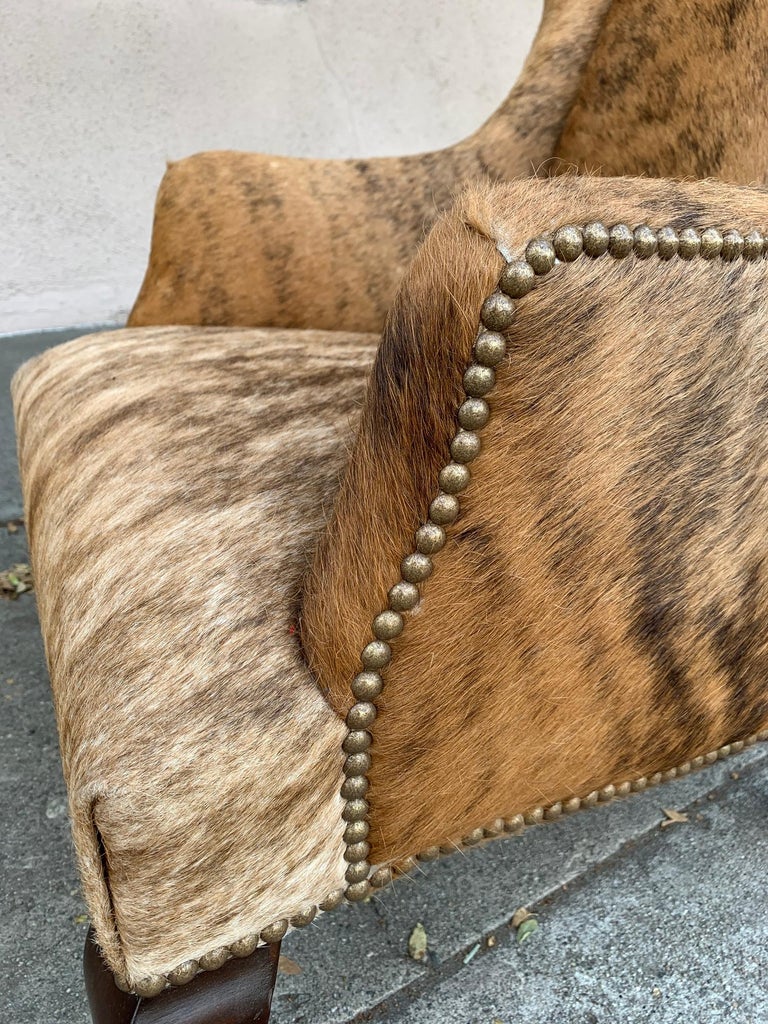 Pair of Wingback Chairs 1 in Brown Cowhide and 1 in White Cowhide