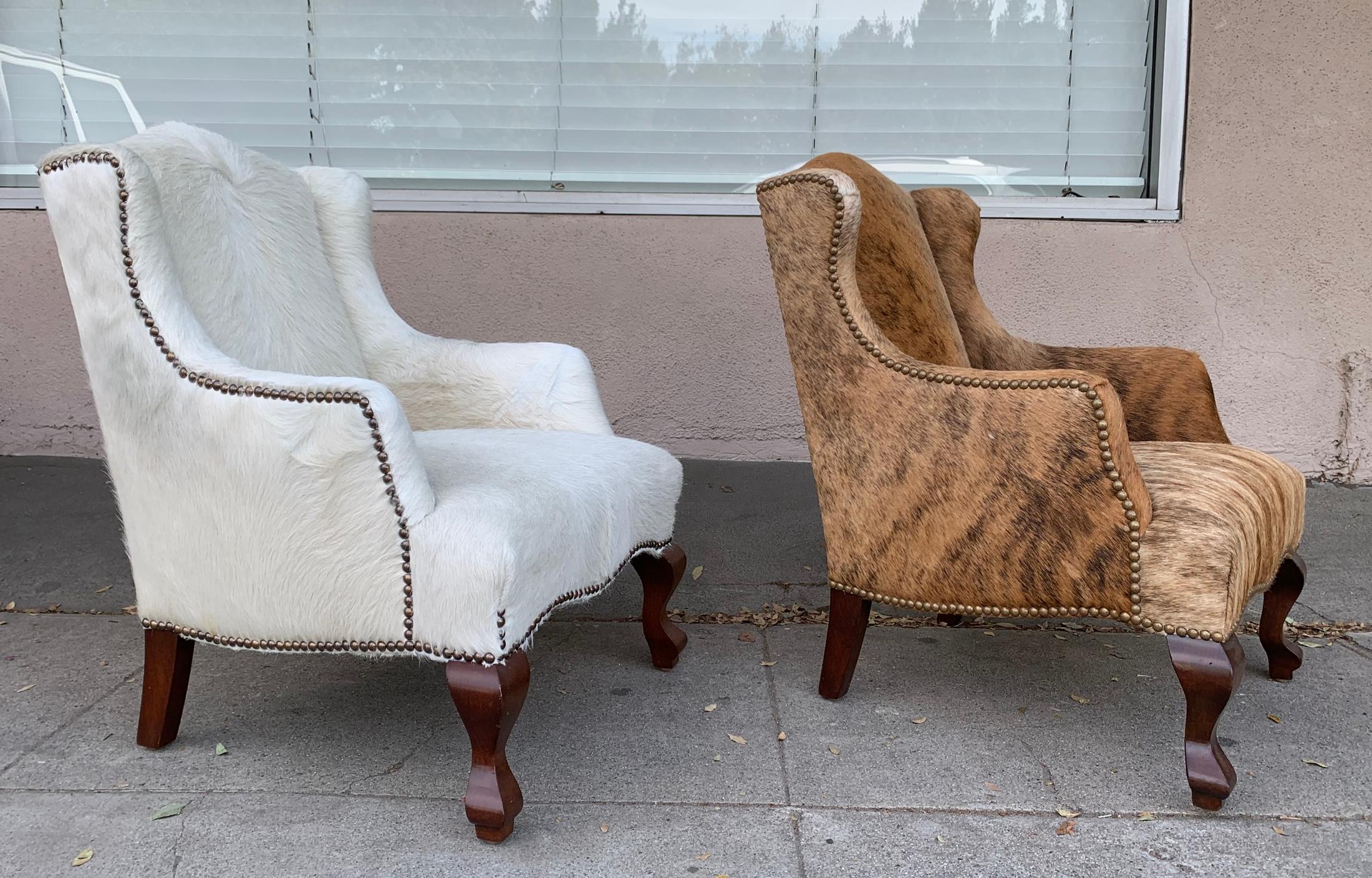 Beautiful pair of wingback chairs, one upholstered in white cowhide leather and 1 upholstered in brown cowhide leather, newly upholstered, the chairs have cabriole style legs in dark mahogany wood.
Measurements:
28.5” high x 20” wide x 24.5” deep