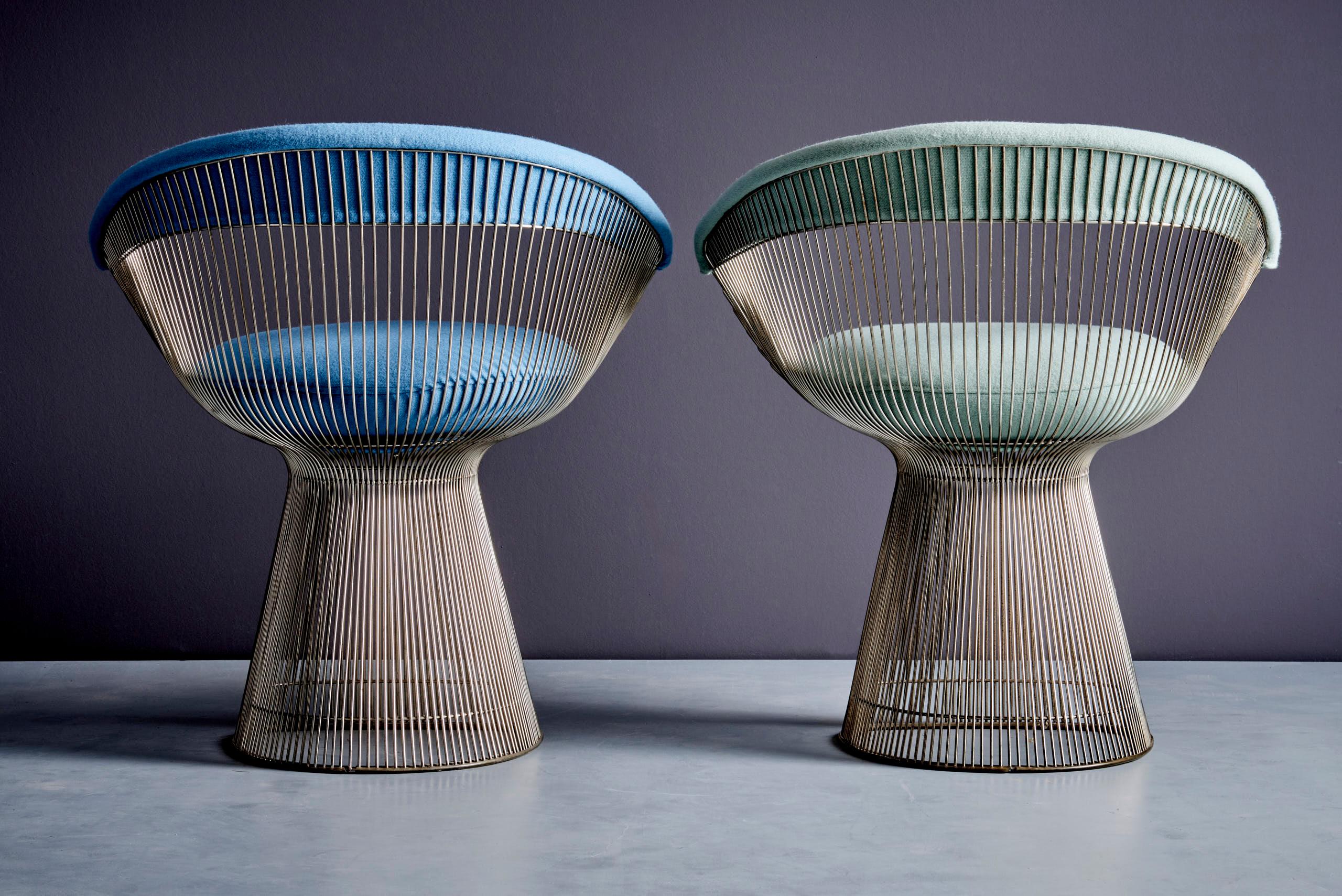 Pair of wire chairs designed by Warren Platner for Knoll International in the early 1960s. Early production pieces with steel wire bases, upholstered in blue and grey fabric. A true modern design icon. Vintage condition with light wear consistent