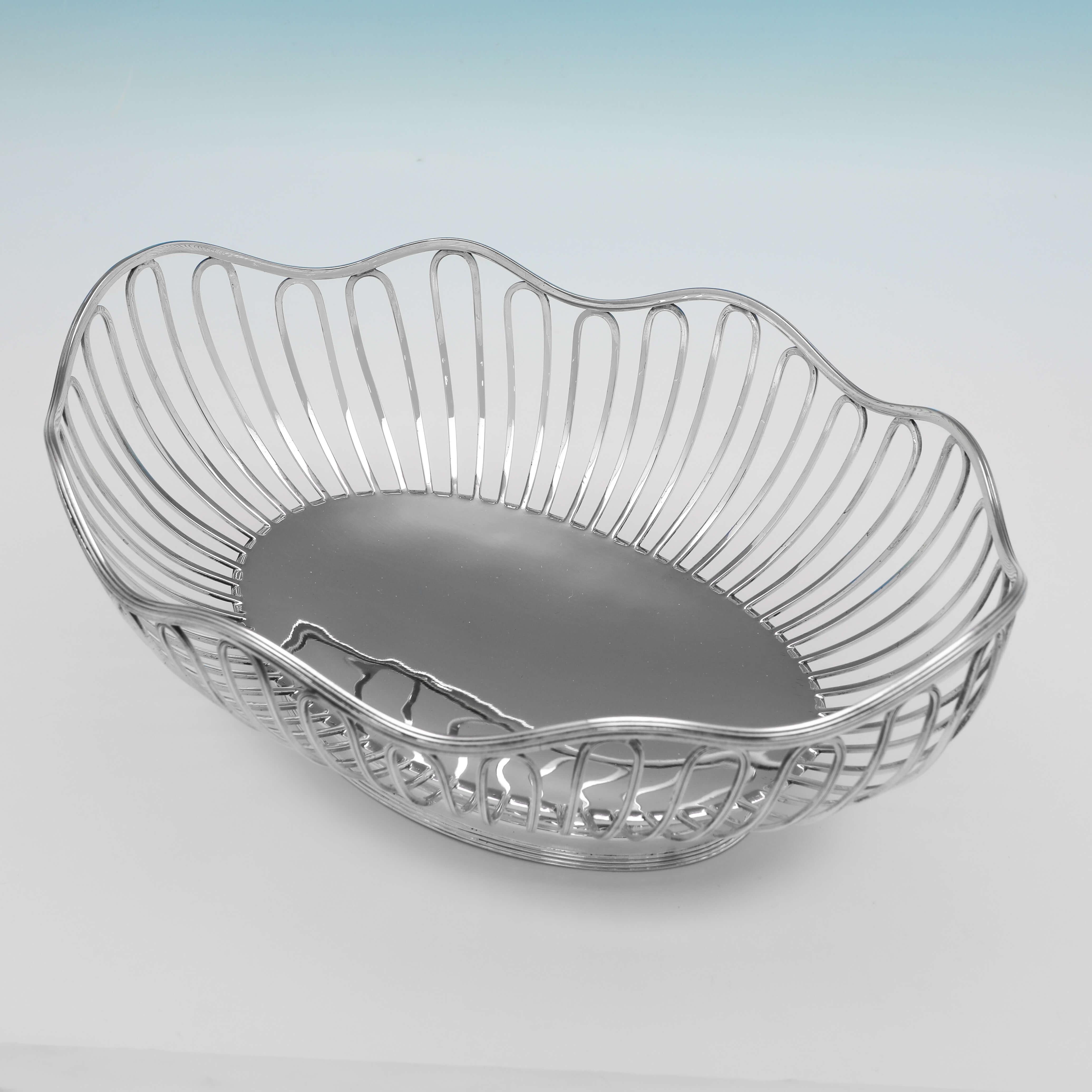 Hallmarked in Sheffield in 1914 by Walker & Hall, this stylish Antique Sterling Silver Dish would make a very attractive bread dish for the table, featuring wirework sides, and a shaped border. 

The dish measures 4
