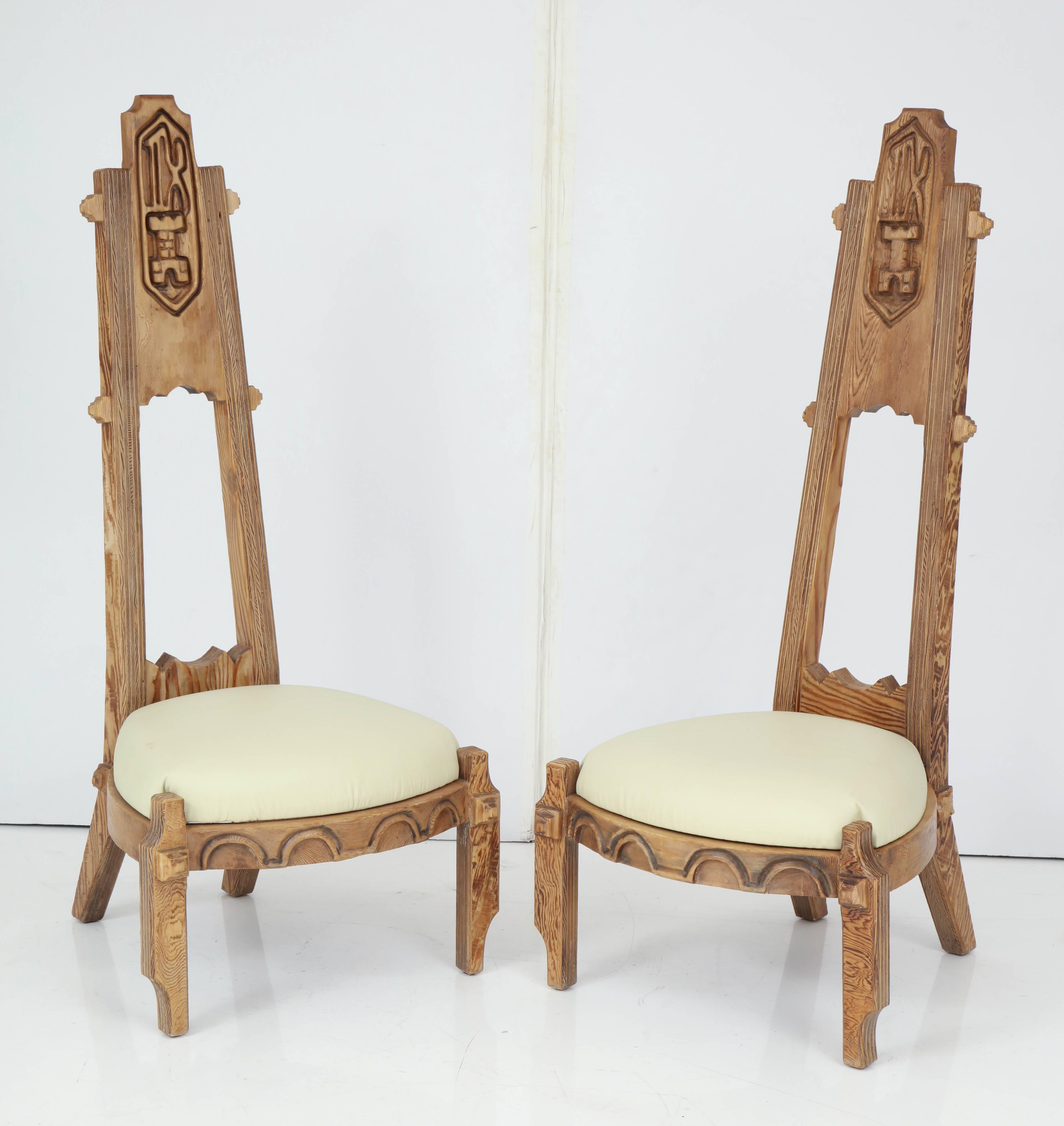 Pair of chairs with very tall backs having deep carved designs of Bishops from chess game with white leather seats.