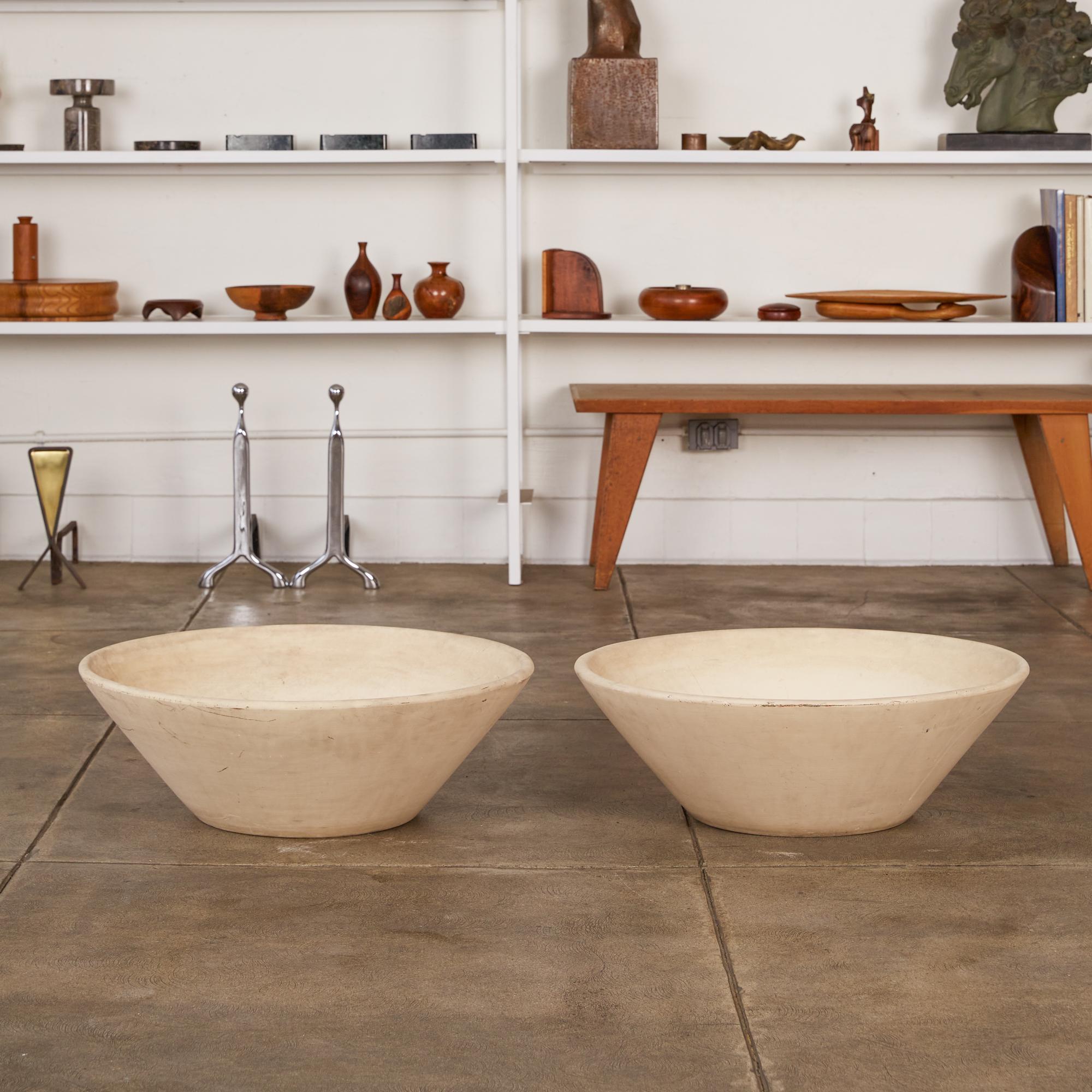 Pair of Lagardo Tackett’s iconic planters for Architectural Pottery, colloquially known as the “wok,” has sharply angled sides, smooth edges with no lip, and a flat foot. These examples are patinated and weathered from outdoor use, with a warm cast