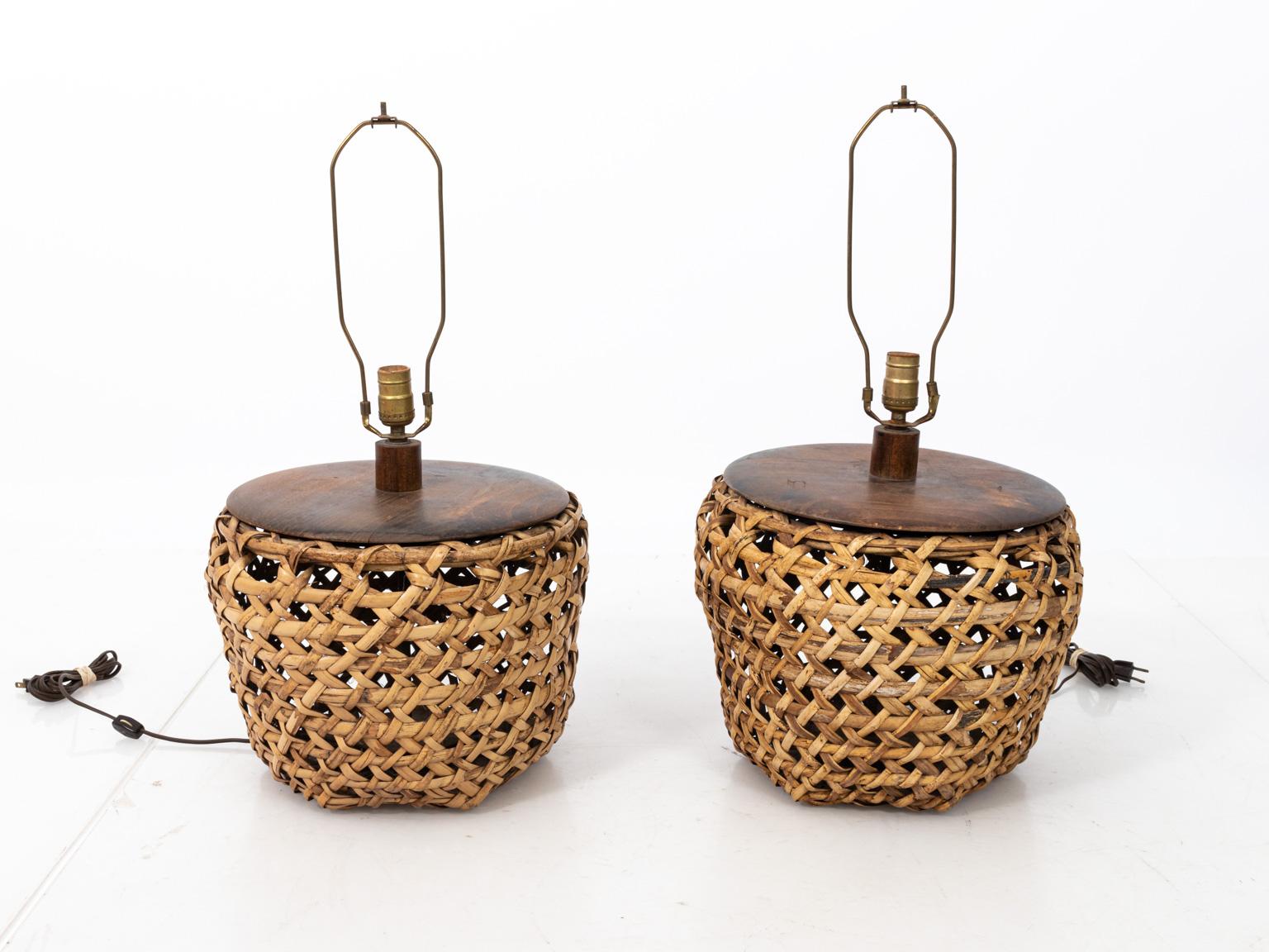 Pair of woven Rattan table lamps with red shades. Please note shades are not included with wear consistent with age including minor loss to the Rattan.