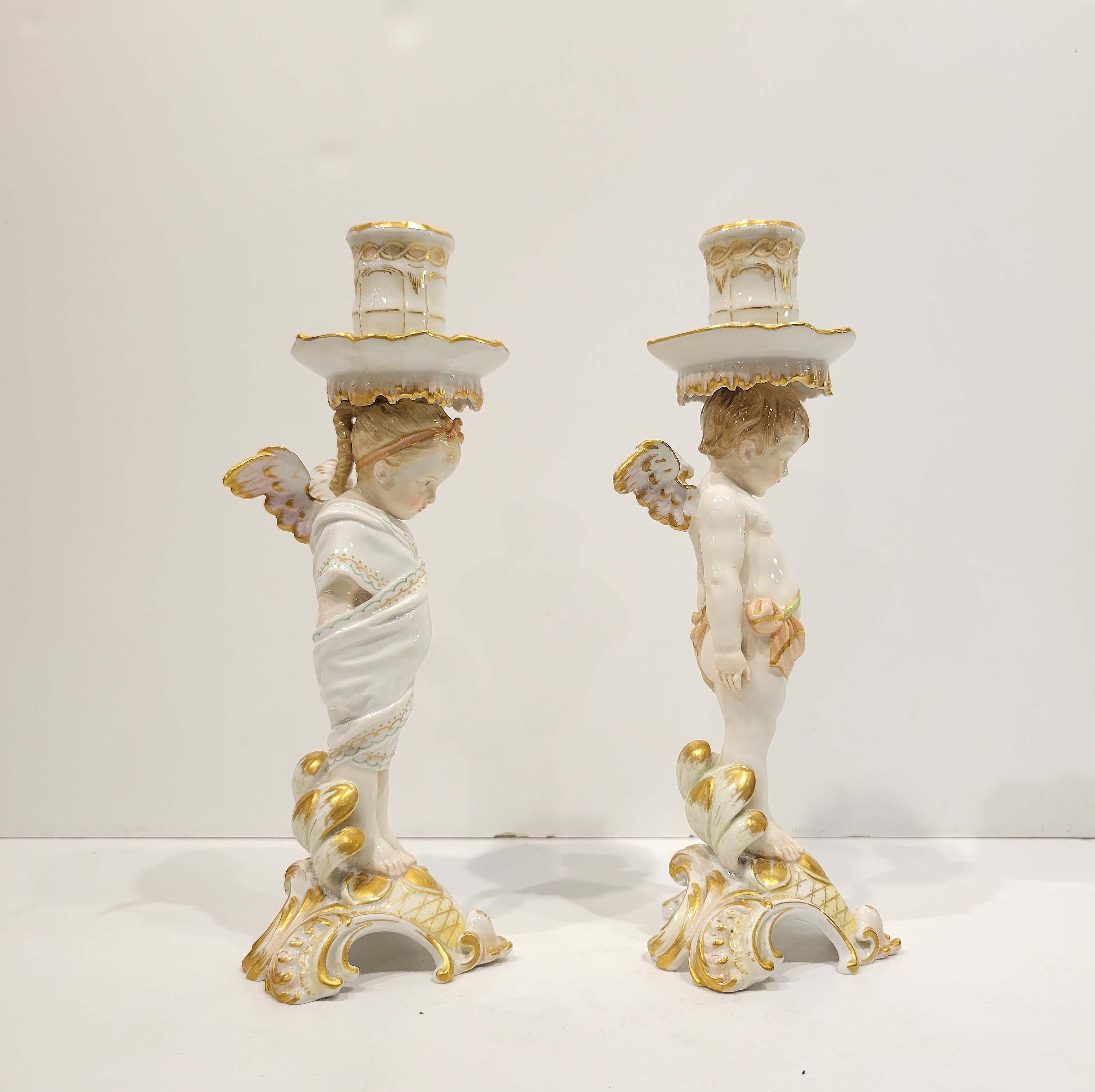 Circa late 19th century, depicting two infant cherubs beautifully decorated in Rococo style. Each with KPM scepter marks underglazed and red circle and cross marks. The Königliche Porzellan-Manufaktur Berlin, or KPM (Royal Porcelain Factory, Berlin,