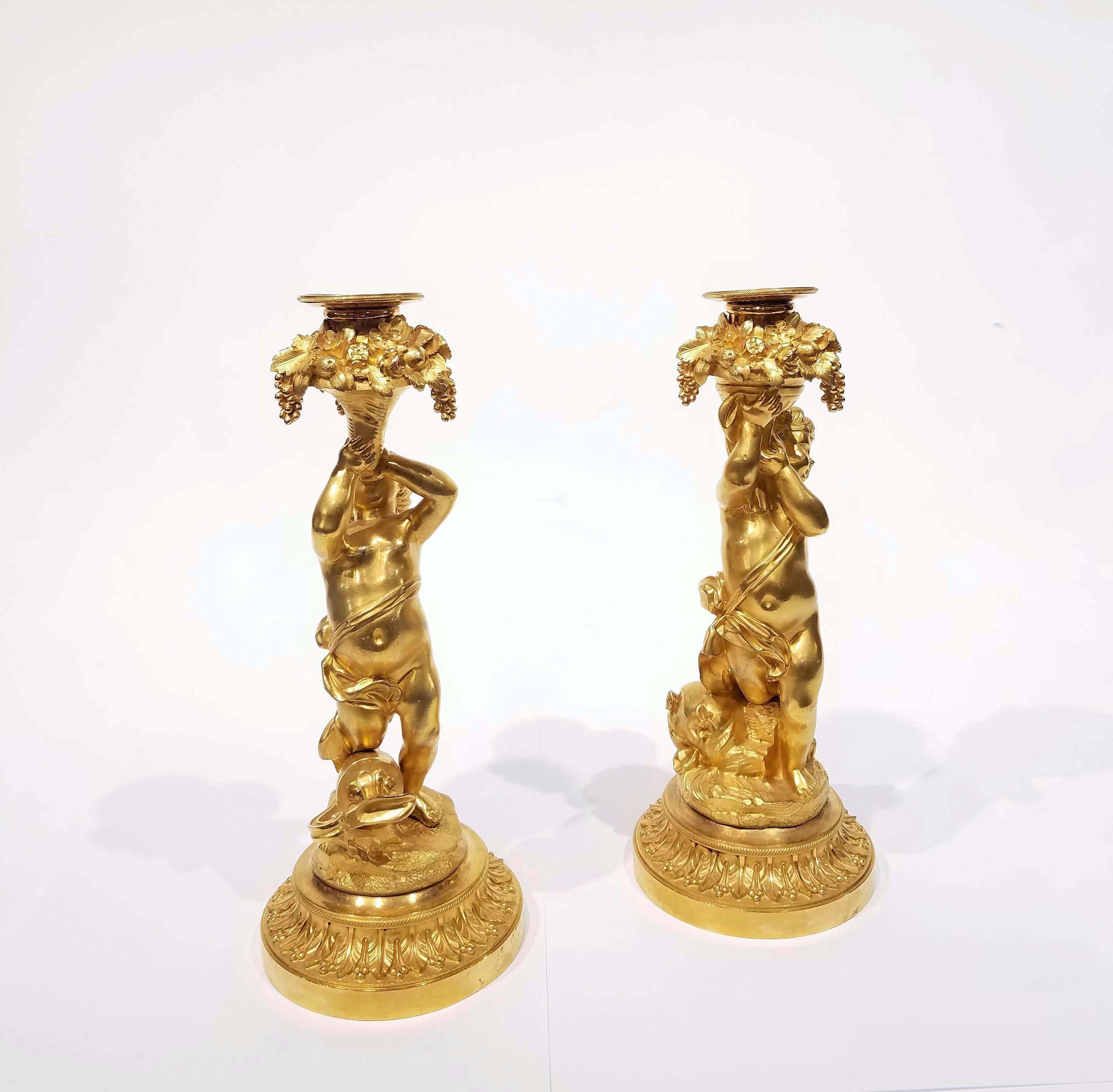 A wonderful Louis XVI style ormolu bronze figural cherub candlesticks, circa mid-19th century, mercury gilded with exquisite casting and details. Good condition. Measure: 10