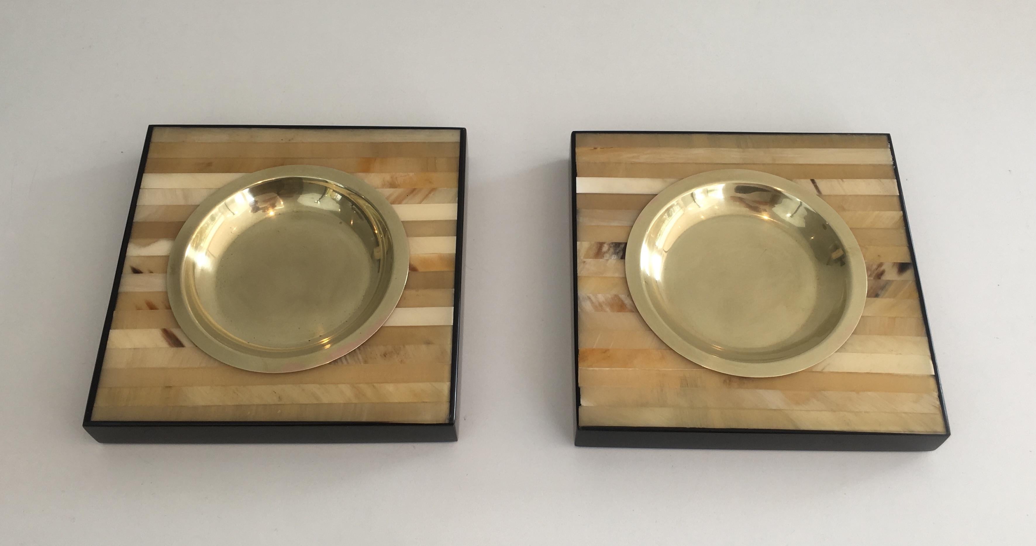 This pair of ashtrays or vide-poches are made of wood and brass They are from Italy and one of them has a sticker showing this is an Italian piece. These are circa 1970 and are sold individually.