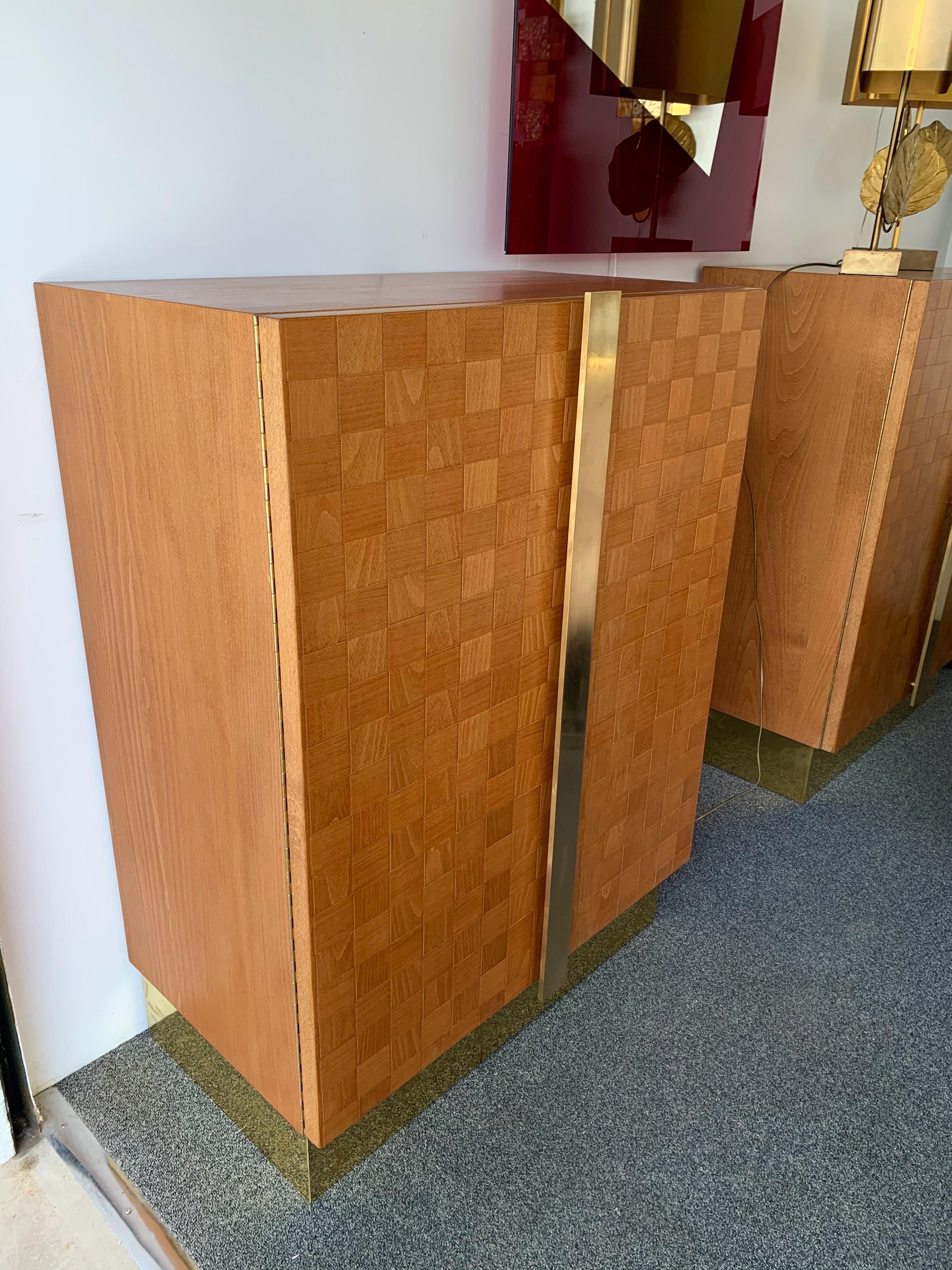 Pair of full massive wood cabinets or buffets by the Italian manufacture Giorgetti , brass plated base and brass handle. Fine wooden checkerboard inlay or marquetry on doors.