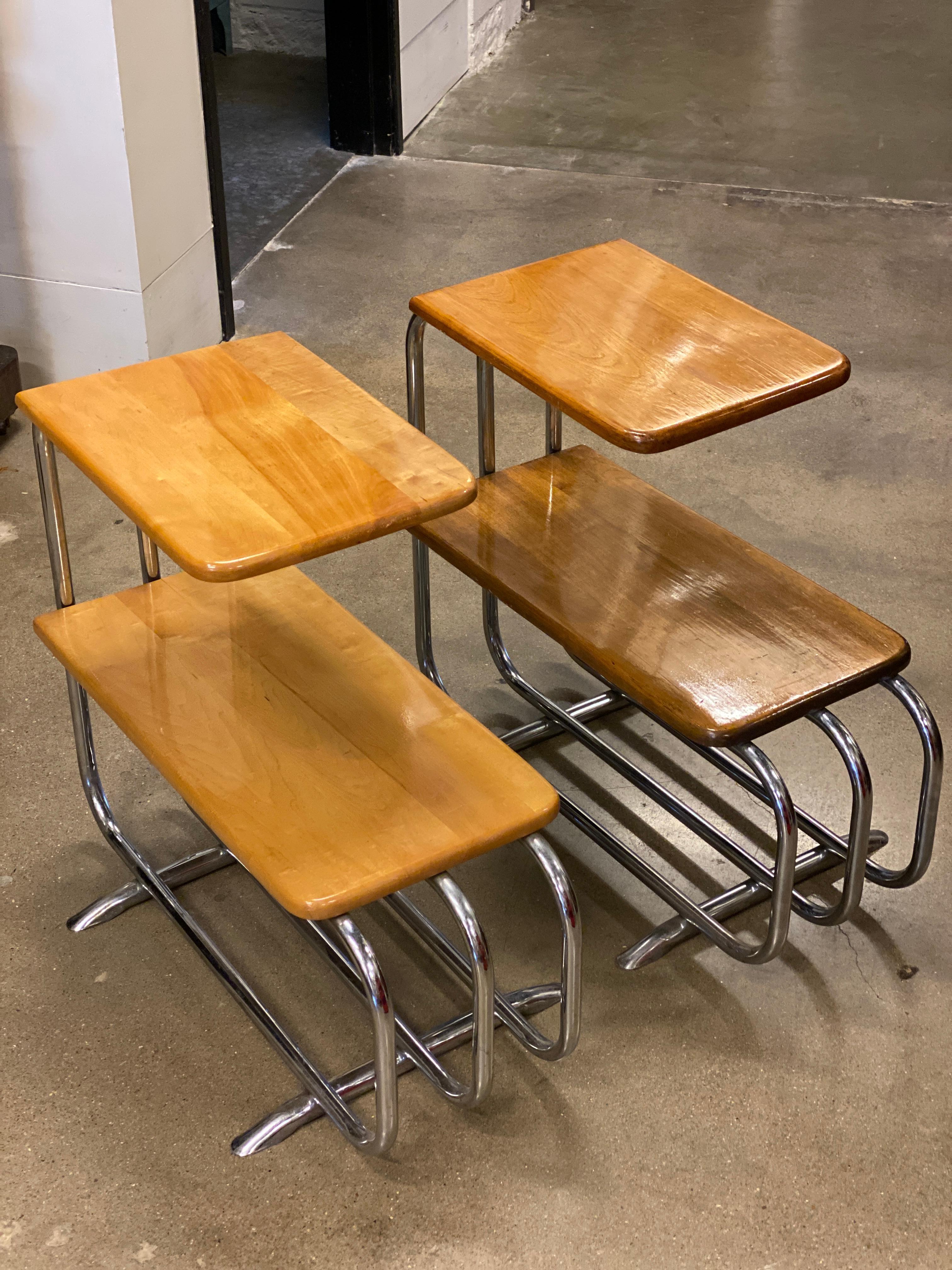 Pair of side tables by German industrial designer, Alfons Bach. Art Deco style tubular steel frames with hardwood top and lower surfaces. Produced by Lloyd Manufacturing Company in Menominee, Michigan, from the 1930s until 1947.