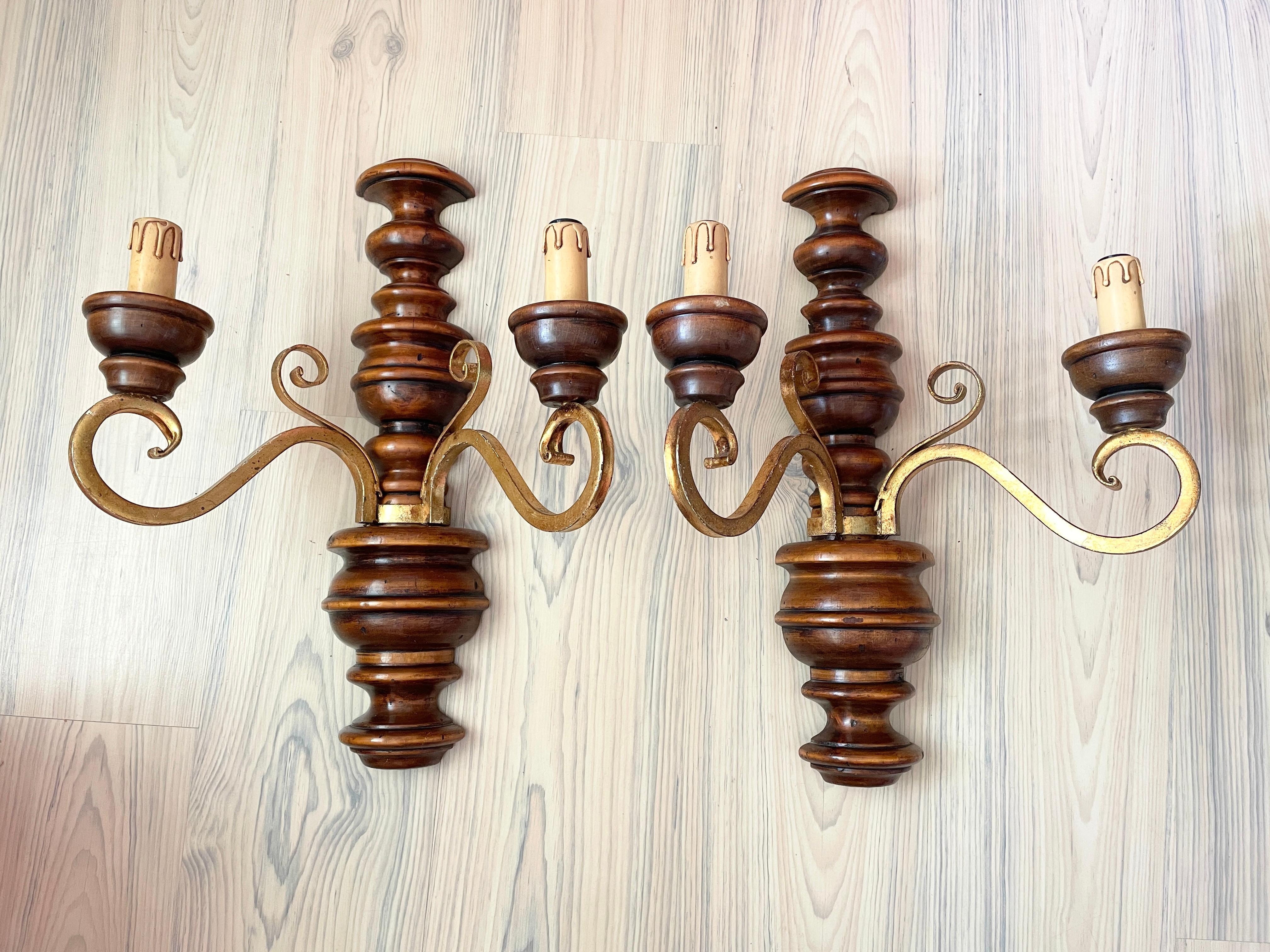 A pair rustic wood and gilt metal Sconces, each fixture requires two European E14 candelabra bulbs, each up to 40 watts. The wall lights have a beautiful patina and give each room a eclectic statement.