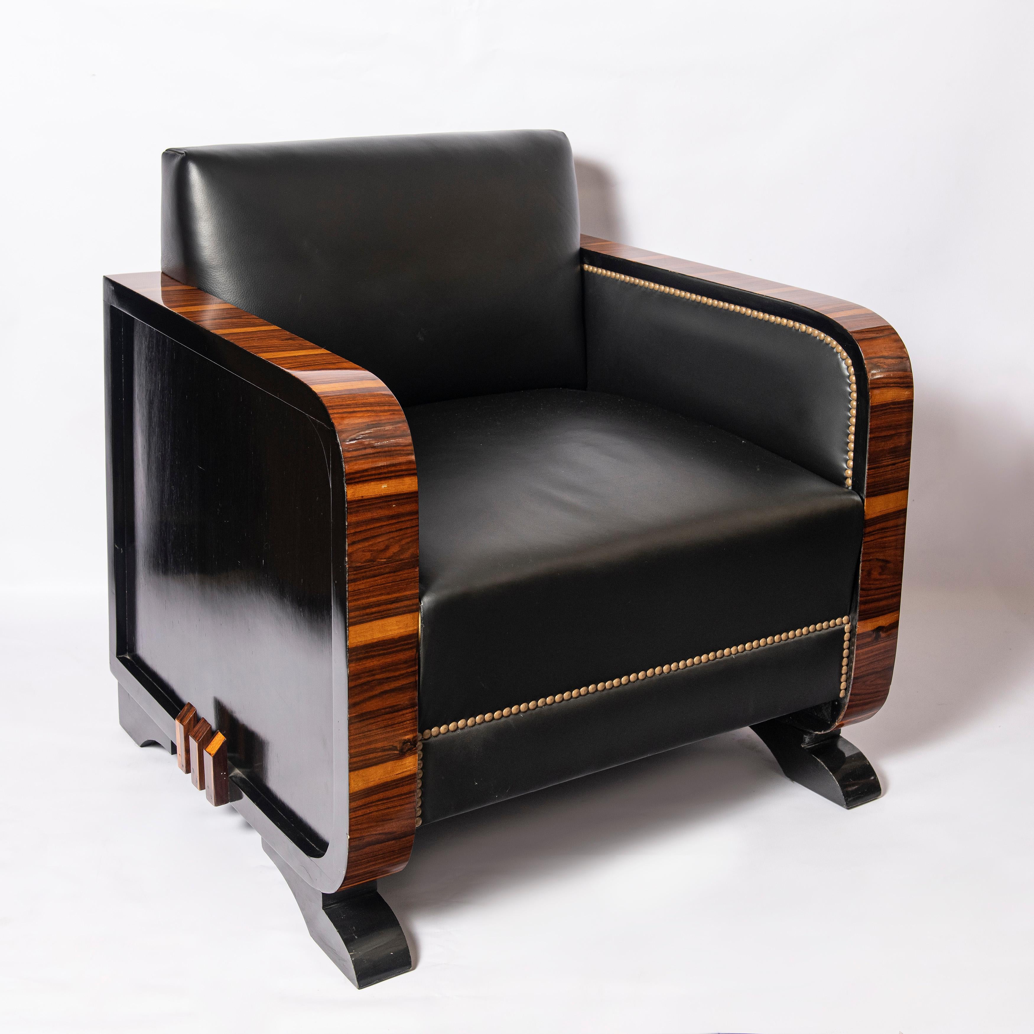 Pair of wood and leather armchairs. Art Deco period, France, circa 1940.