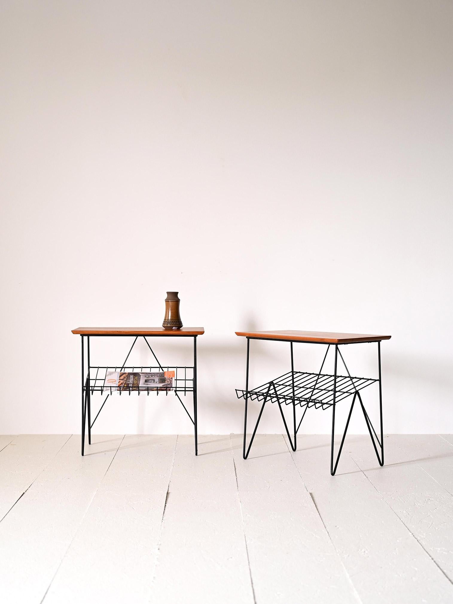 Vintage 1960s nightstands of Swedish provenance.

These Scandinavian furniture pieces are distinguished by simple shapes and the use of metal juxtaposed with wood, a typical element of mid-century design.
They feature a teak table top and a black