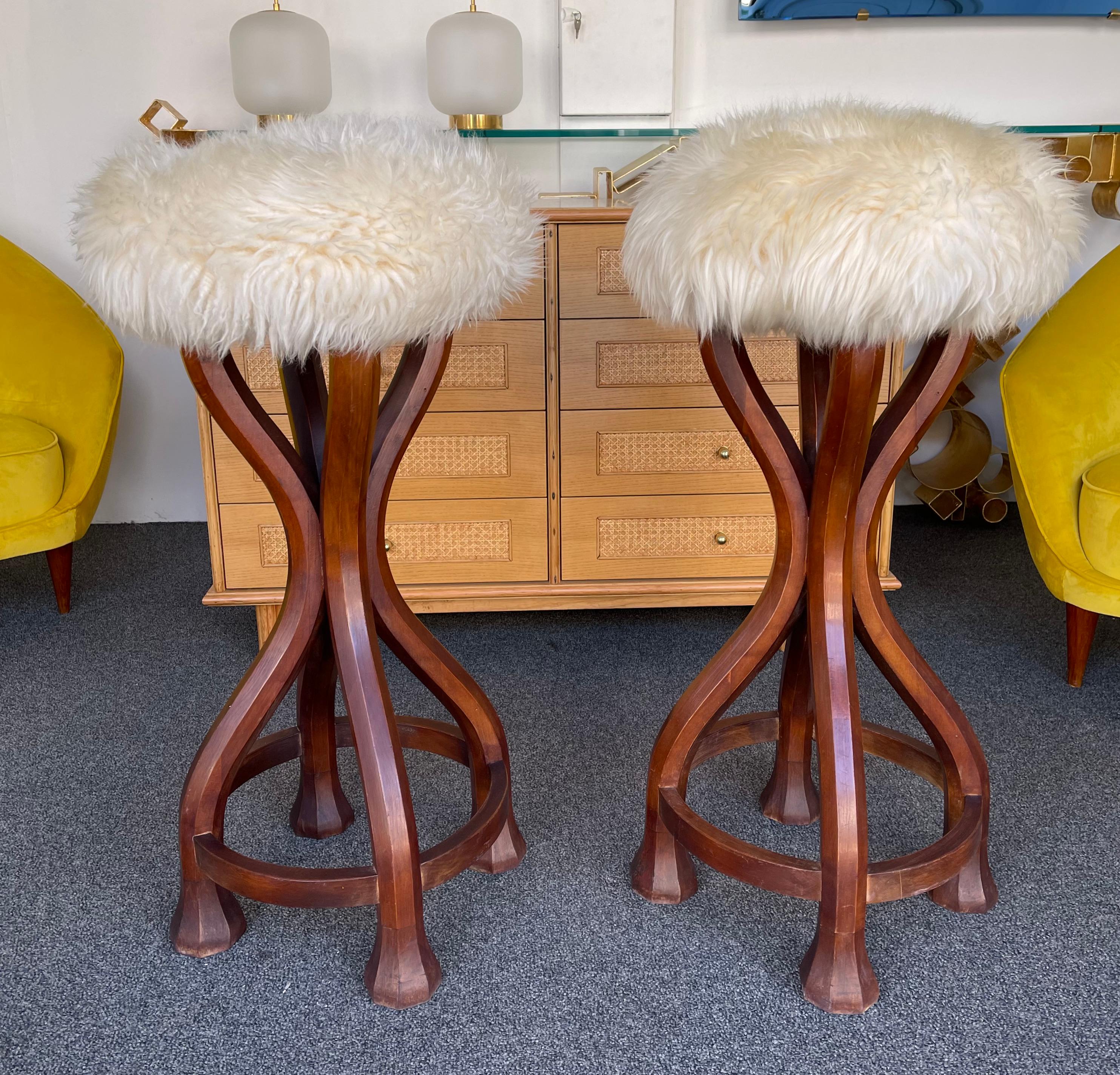 Pair of massive wood and sheepskin sheep fur leather top bar stools. In the mood of Art Nouveau, Art Deco, Mid-Century Modern mood.