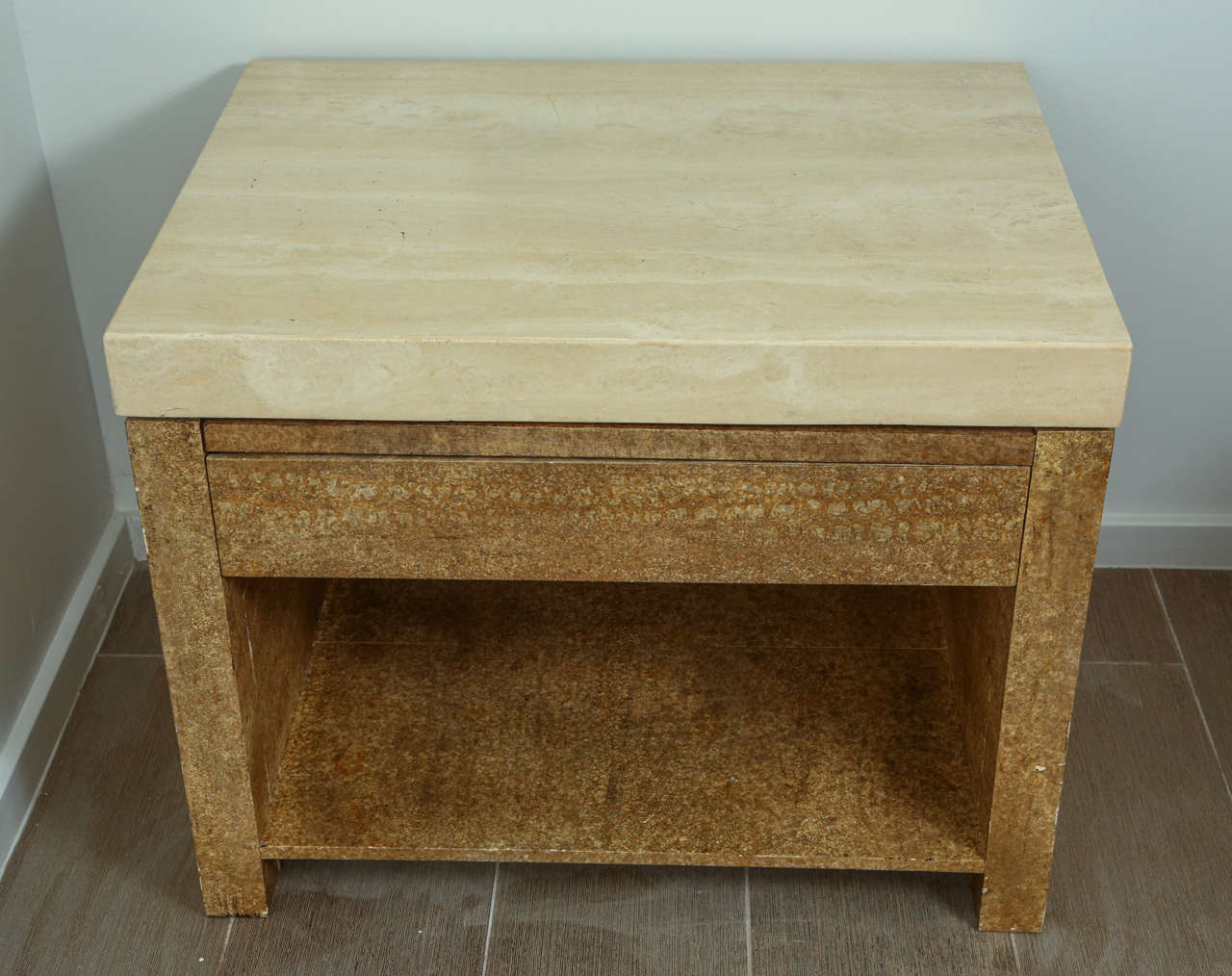 Pair of wooden end tables with travertine tops. The wood has a faux stone finish. Each has one drawer with a pull-out shelf above. Each has an open shelf at the bottom.
wear consistent with age