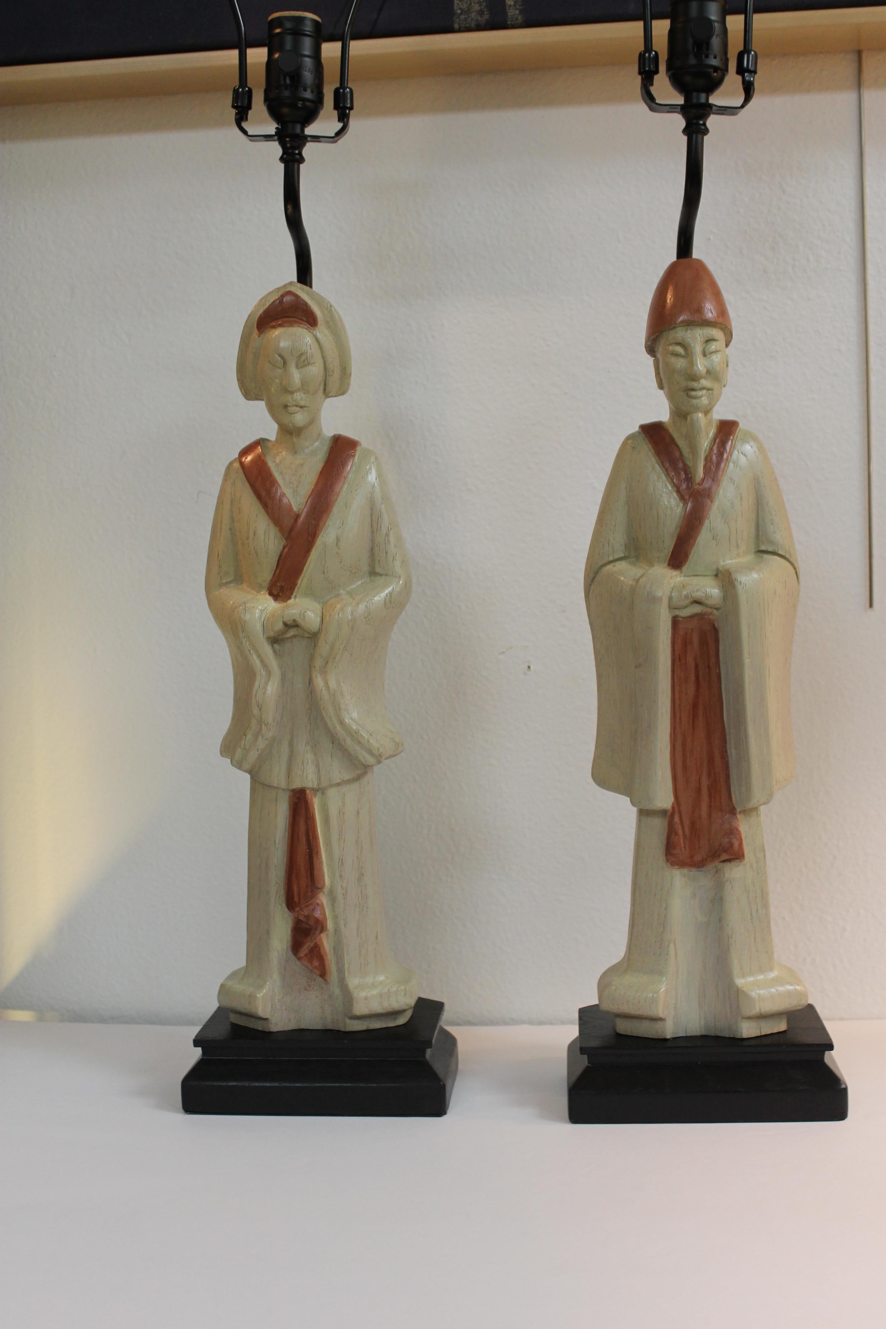 Pair of wood Asian lamps. Wood has been refinished highlighting the robes and head dress. They measure 23