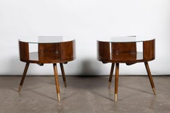 Pair of wood, glass and bronze round coffee tables. Argentina, circa 1960.