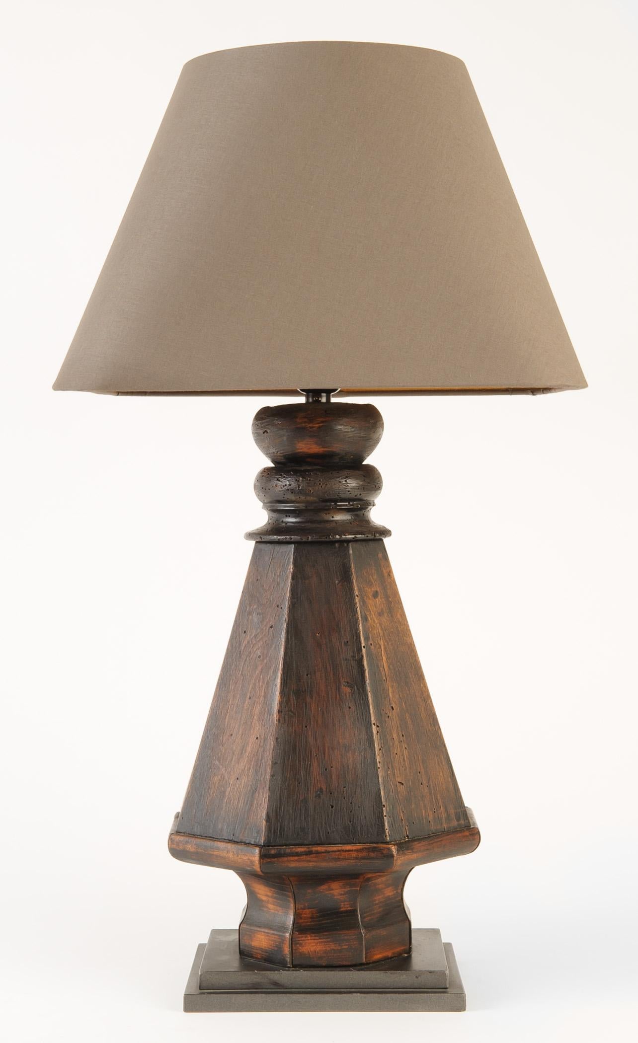 This pair of wood lamps are created from the legs of a billiard table. The base is mounted on a graduated metal squares. The custom taupe linen shade is square with rounded corners and bronze paper liner. The lamp has high low control and is wired