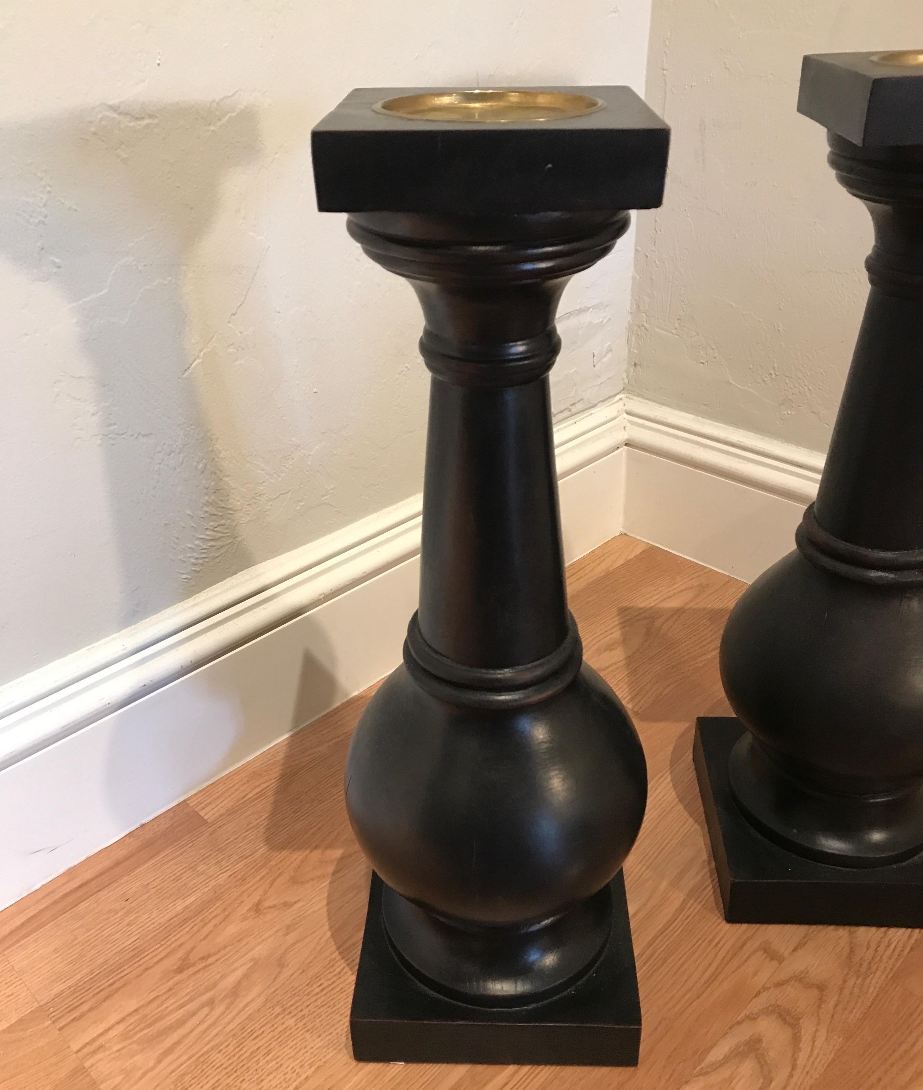 Imposing pair of wood pillar/column style candlesticks.