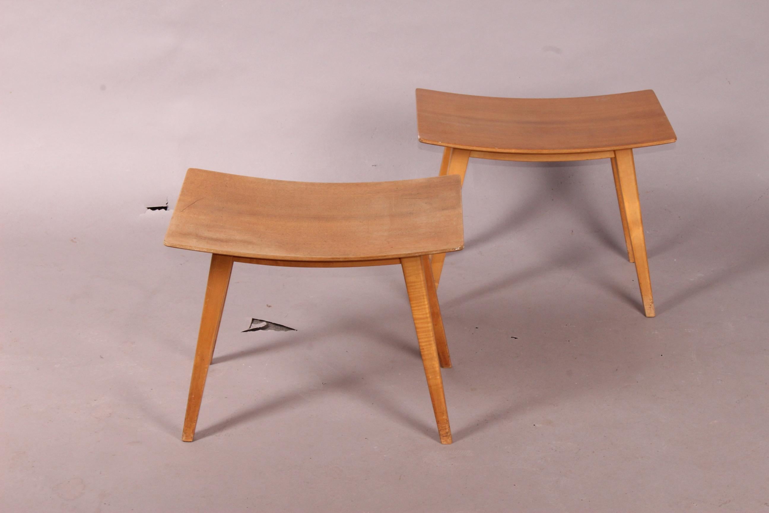 Pair of curved wood stools.
