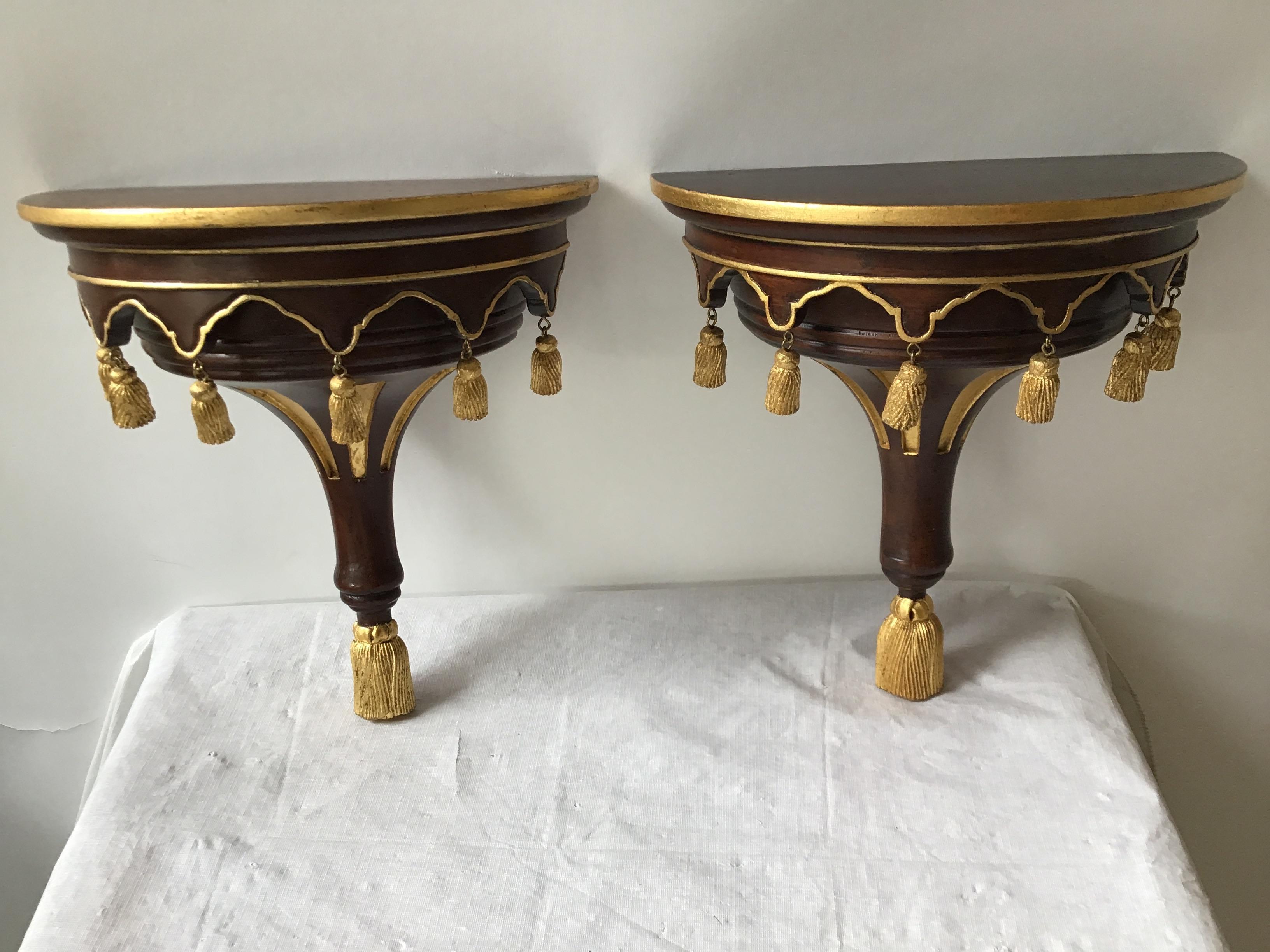 Pair of solid wood wall shelves with gilt tassels.