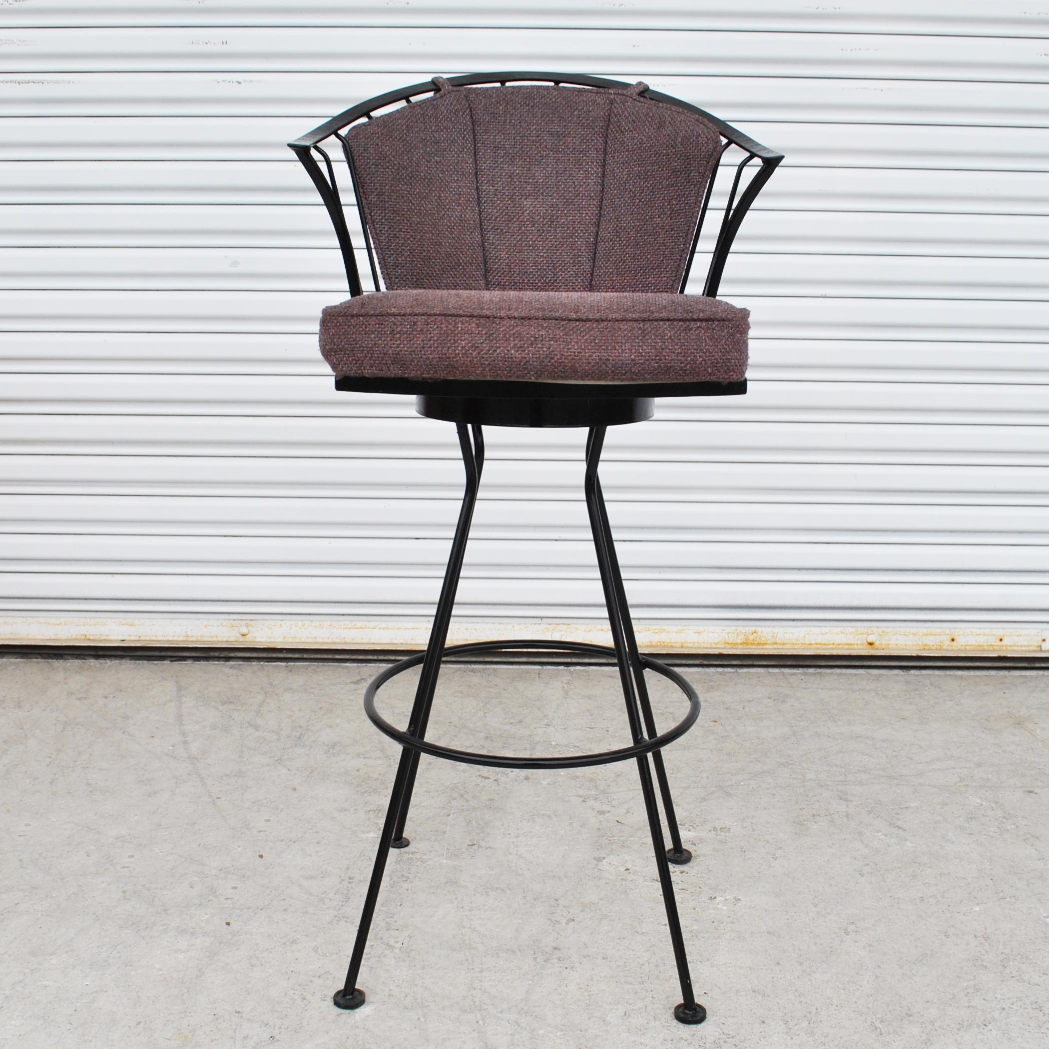 A pair of mid century modern stools made by Woodard.  Black wrought iron frames with burgundy cushions.
32