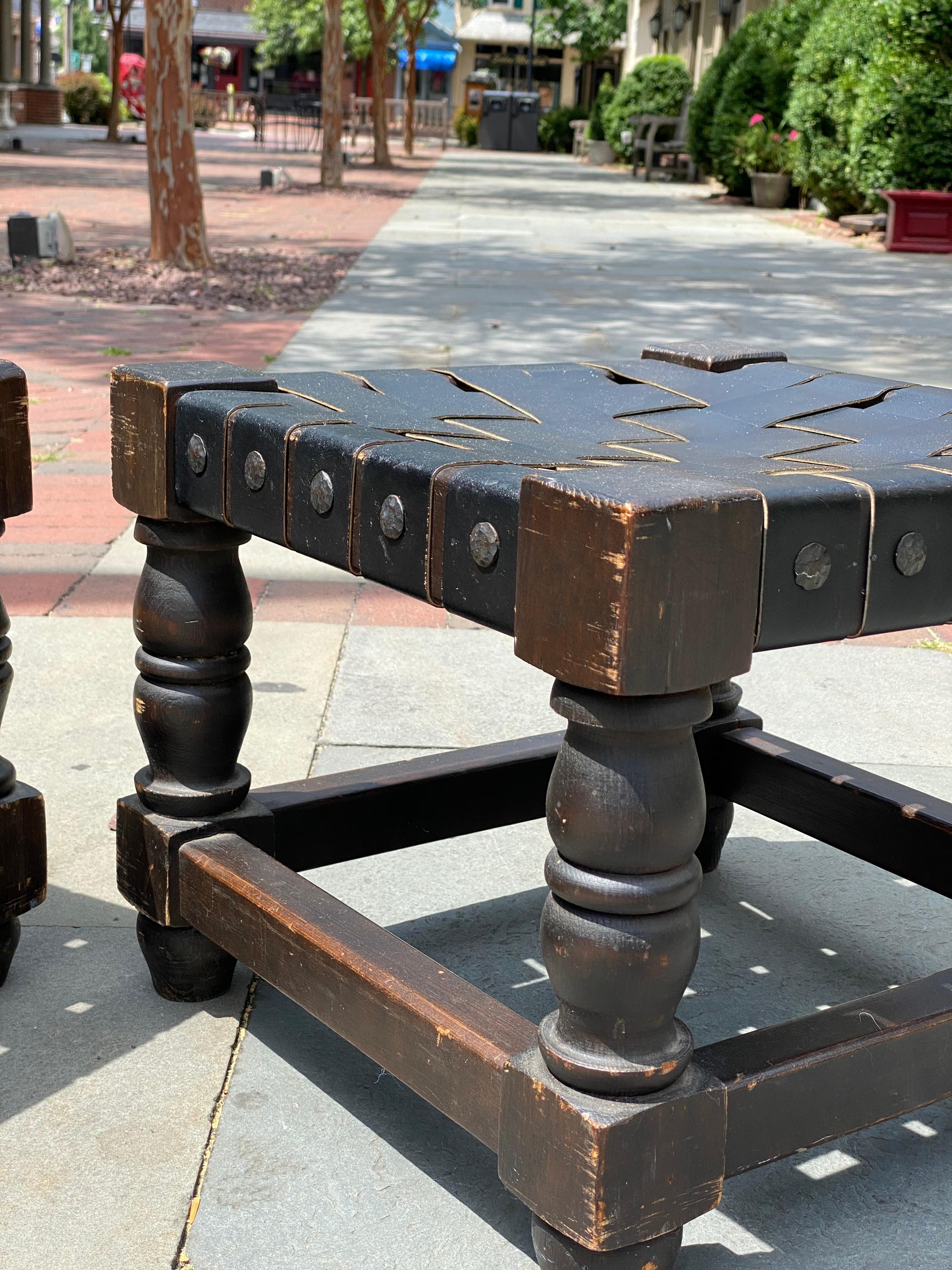 Blackened Pair Of Wooden And Woven Black Leather Straps Stools