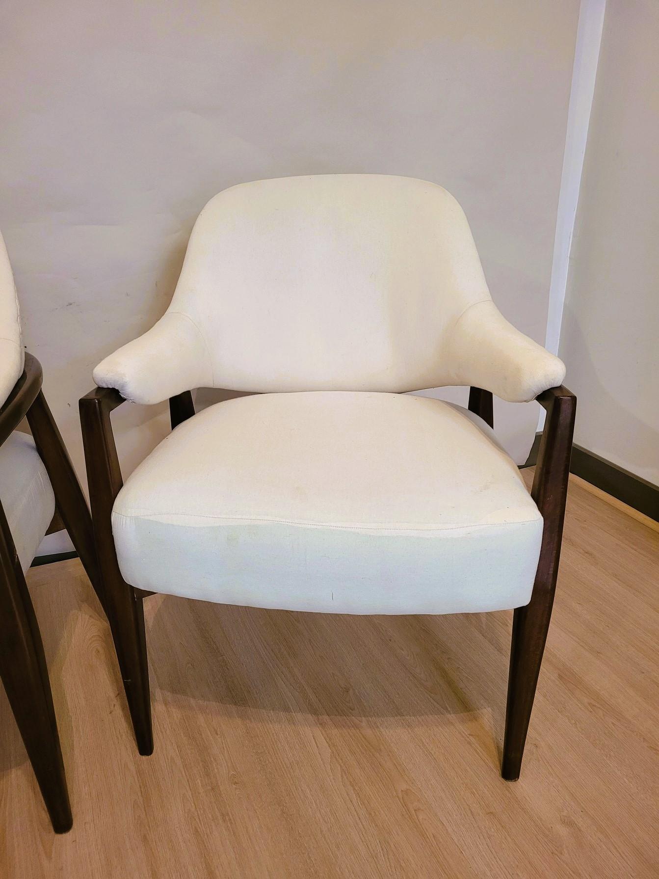 Pair of stained wooden armchairs, with a 