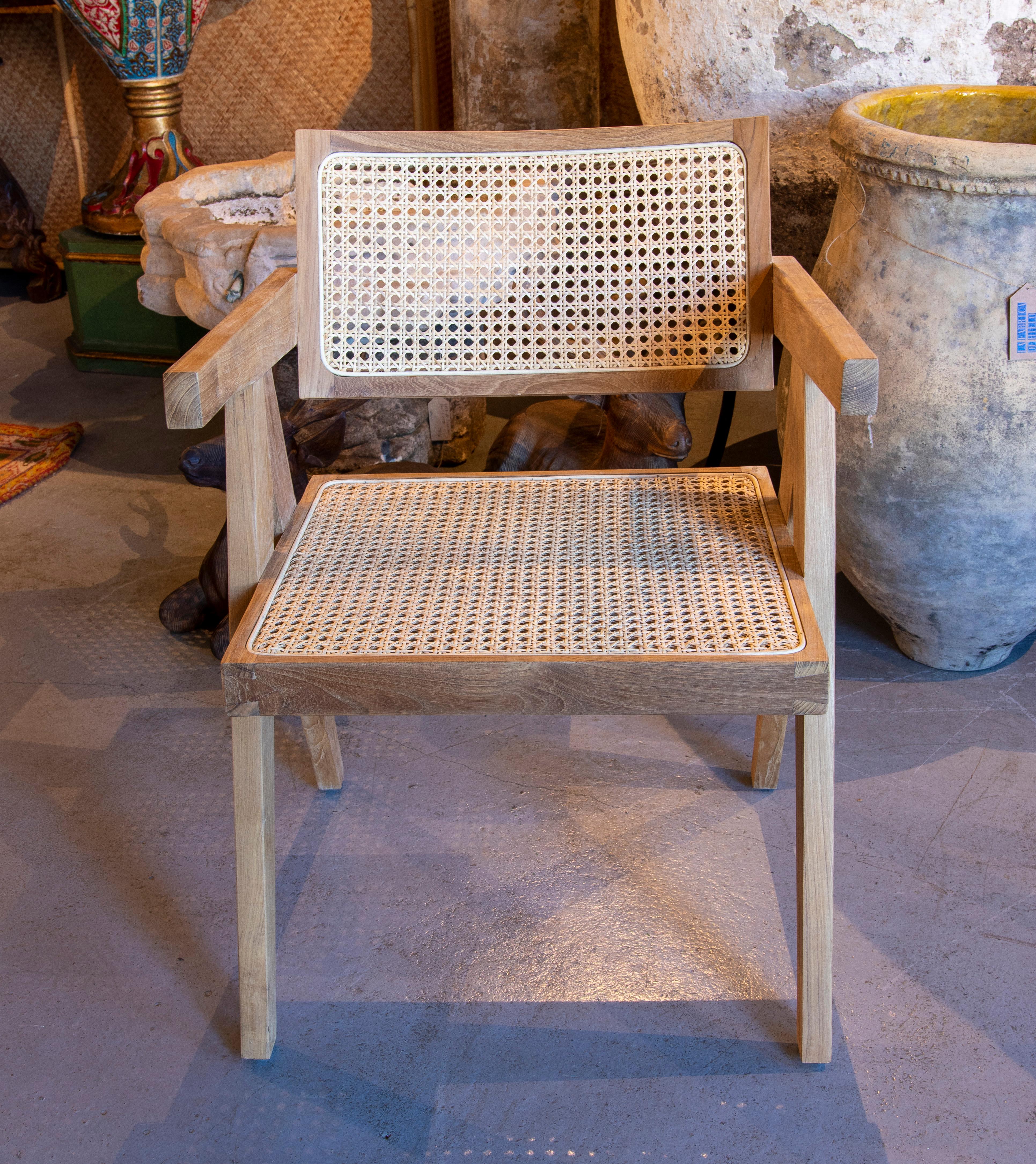 Pair of wooden armchairs with wicker backrest and seat.