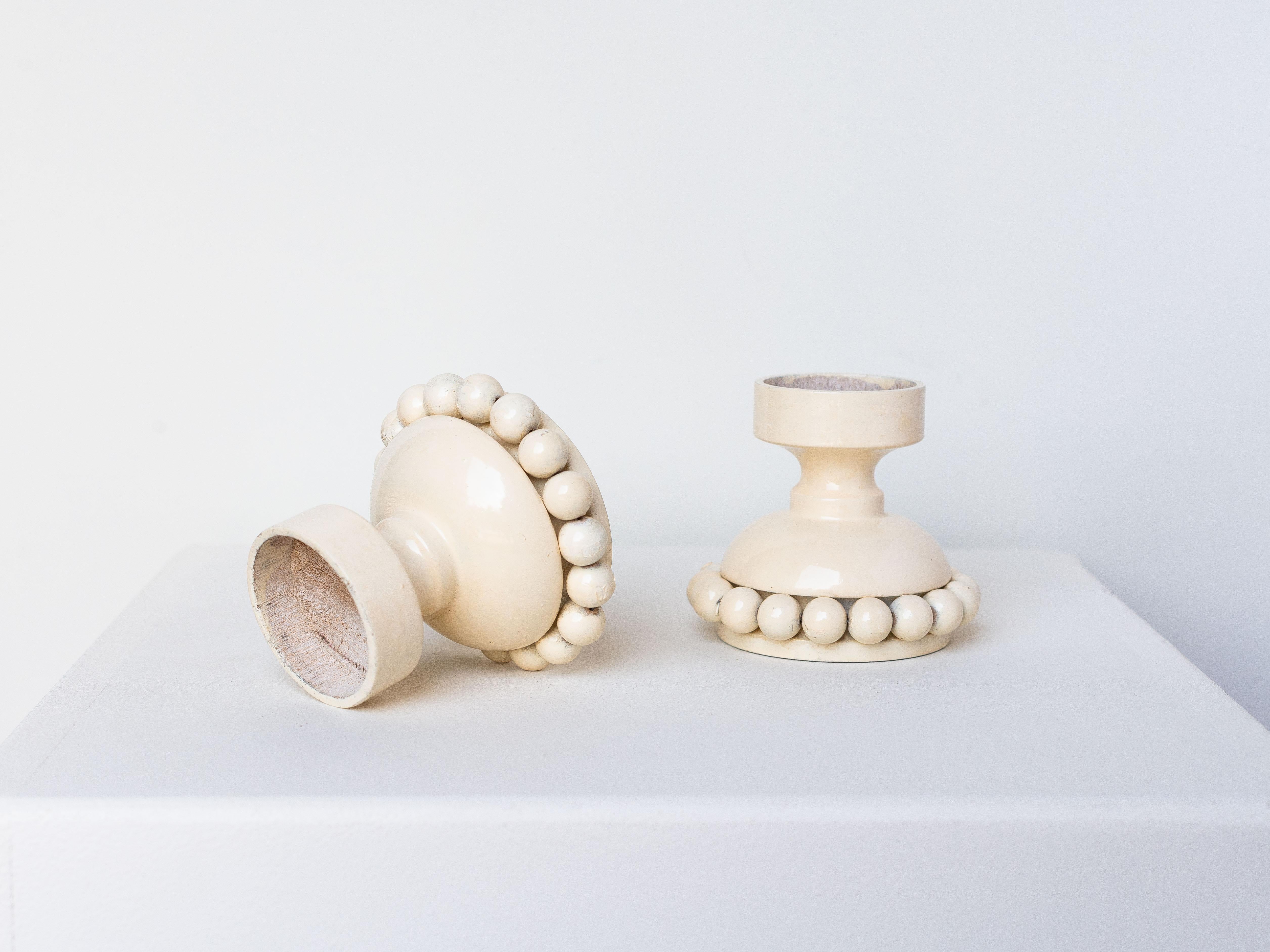 Pair of Wooden Candle Holders by Kaija Aarikka for Aarikka, Finland 1960s.

Made of wood and painted in a creamy shade.

Aarikka is a famous Finnish home decoration brand, founded by Kaija Aarikka in 1954.

Their specialty is the production of