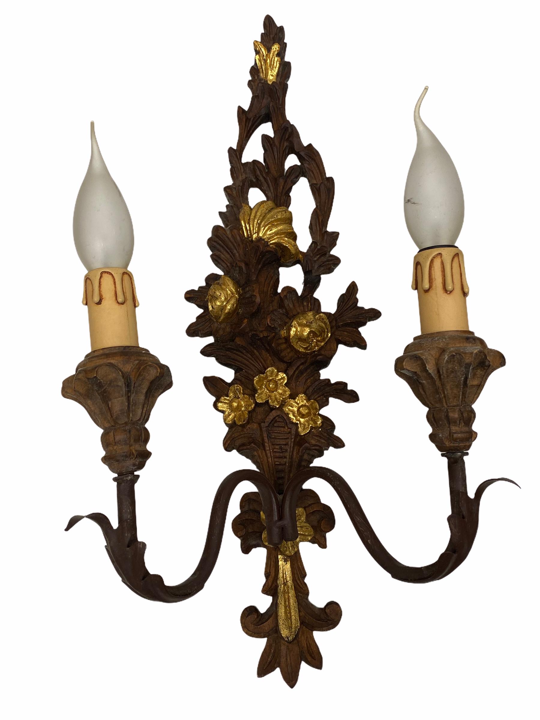 Add a touch of opulence to your home with this charming pair of sconces. Perfect gilt and hand carved wood to enhance any chic or eclectic home. We'd love to see it hanging in an entryway as a charming welcome home. Built in the 1960s, in Italy,