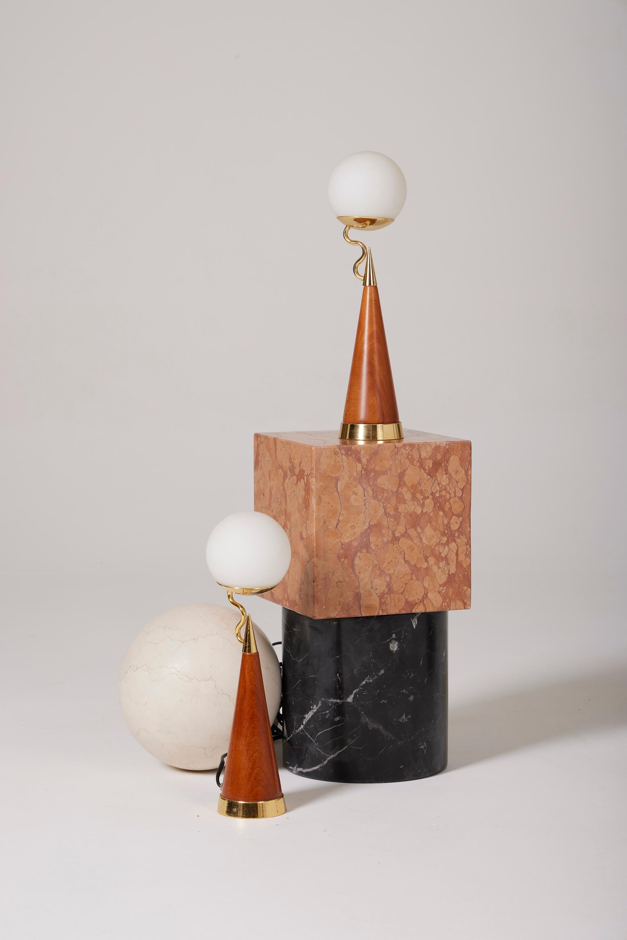 Pair of Castelleone table lamps, 1980s. The base is a cone-shaped wooden design with a section in gold metal at the foot and on the upper part. Frosted glass globe connected to the lamp base. Electrical cord with switch and transformer, functional,